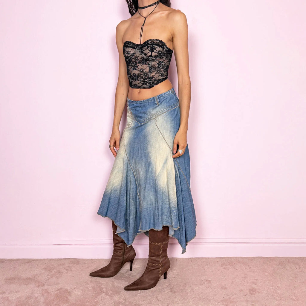 Vintage 2000s blue denim midi skirt with an avant garde flared asymmetric silhouette and panelled construction. Features a soft faded wash, raw hem detailing, and side zip closure, no stretch. Unique bold design perfect for summer festival styling. Can be worn high-waisted for size M or mid- to lower-rise for sizes S–XS. Great vintage condition.