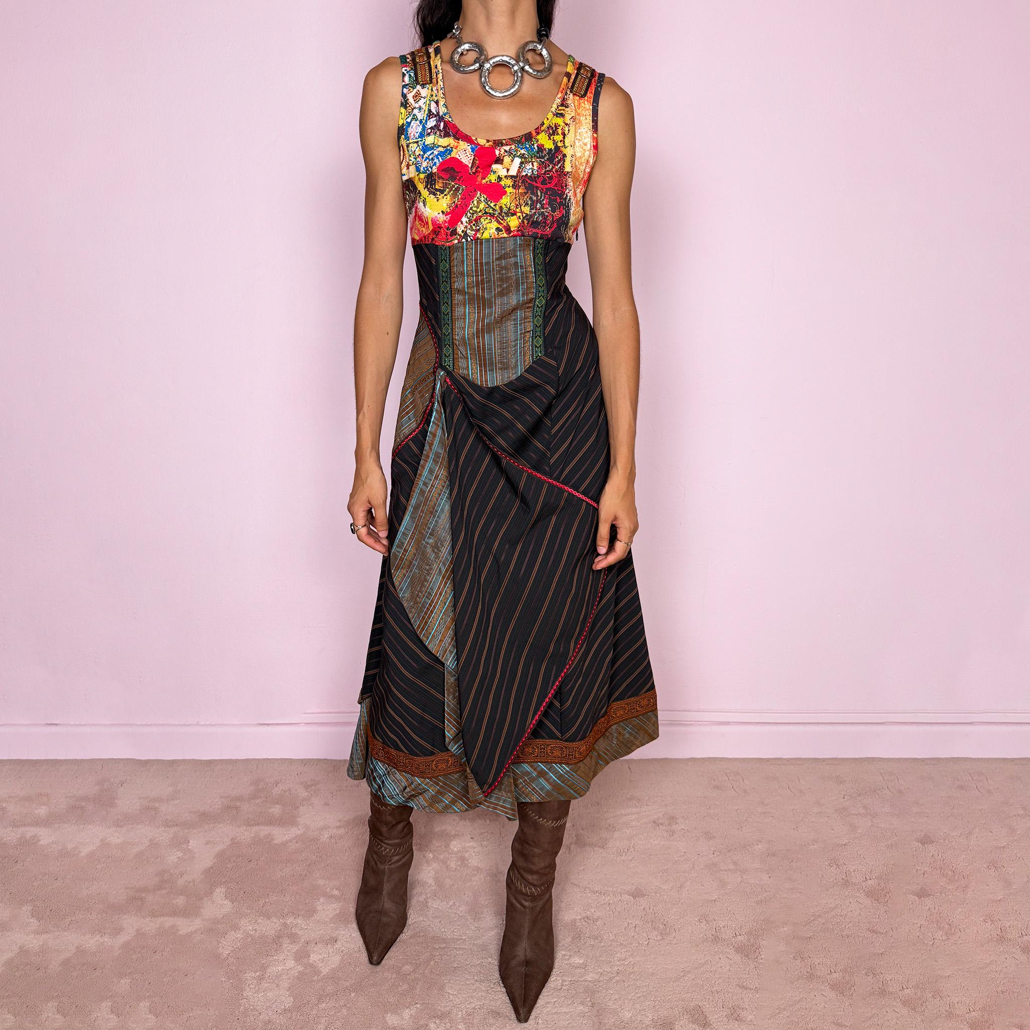 Vintage 2000s midi dress designed with a dramatic medieval-inspired avant-garde silhouette. It features a graphic bust panel with vivid abstract artwork, a fitted corset-effect waist with striped and patterned panels, a side zip closure, and a flowing asymmetric skirt with mixed striped fabrics, contrast trims, and layered draped sections for sculptural movement. Only the bust area has stretch, while the rest of the dress  A rare fantasy statement piece with a theatrical baroque feel.