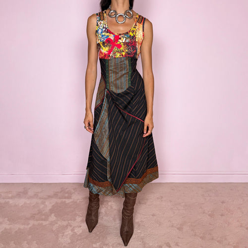 Vintage 2000s midi dress designed with a dramatic medieval-inspired avant-garde silhouette. It features a graphic bust panel with vivid abstract artwork, a fitted corset-effect waist with striped and patterned panels, a side zip closure, and a flowing asymmetric skirt with mixed striped fabrics, contrast trims, and layered draped sections for sculptural movement. Only the bust area has stretch, while the rest of the dress  A rare fantasy statement piece with a theatrical baroque feel.