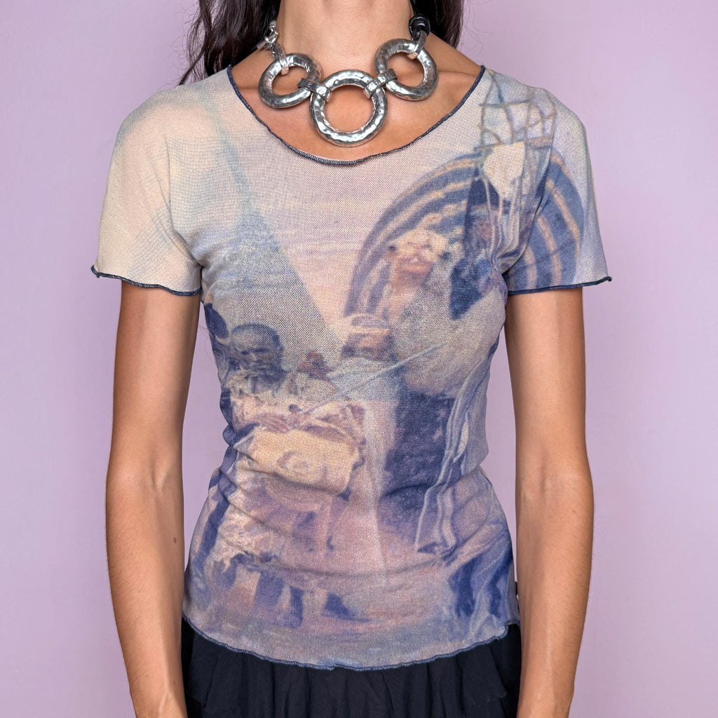Vintage 2000s semi-sheer mesh top featuring an artistic photographic-style graphic print in muted beige and navy blue tones, with a fitted second-skin silhouette and short sleeves. The design has an art-to-wear feel with understated avant-garde appeal, perfect for bold, ethereal outfits. Designed by Finnish designer Ritva Falla for Marimekko and made in Finland from stretchy 100% polyamide. Excellent vintage condition.