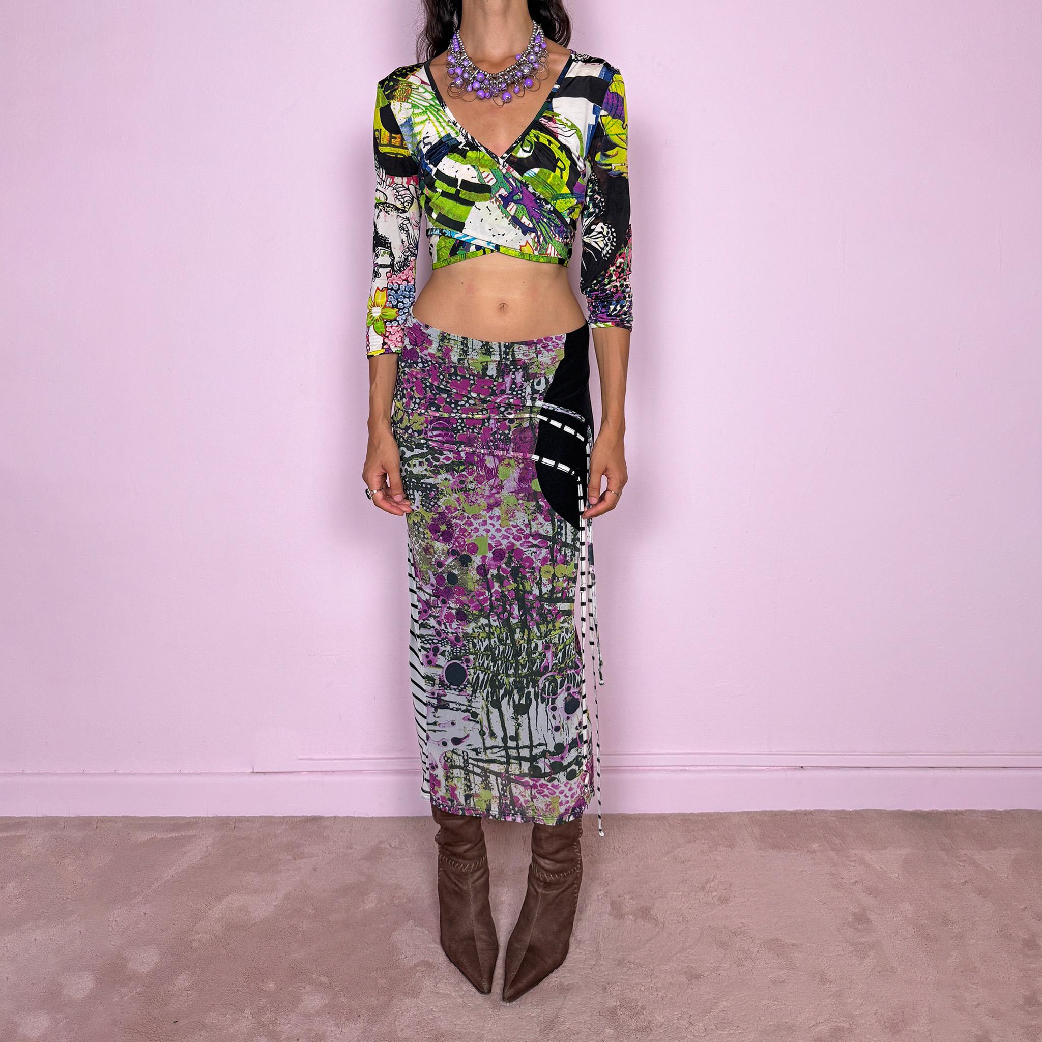 Vintage 2000s two-piece set featuring a fitted wrap-style crop top and matching printed midi skirt. The top has three-quarter sleeves, a deep V-neckline, and an adjustable tie-back closure. The matching skirt is made from stretchy mesh with an elasticated waist and abstract graphic print, featuring ruched detailing through the hip and decorative trailing straps for an asymmetric, deconstructed finish. It can be worn mid- to low-rise.