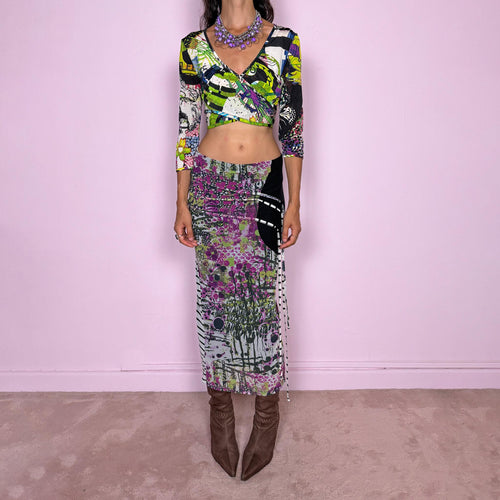 Vintage 2000s two-piece set featuring a fitted wrap-style crop top and matching printed midi skirt. The top has three-quarter sleeves, a deep V-neckline, and an adjustable tie-back closure. The matching skirt is made from stretchy mesh with an elasticated waist and abstract graphic print, featuring ruched detailing through the hip and decorative trailing straps for an asymmetric, deconstructed finish. It can be worn mid- to low-rise.