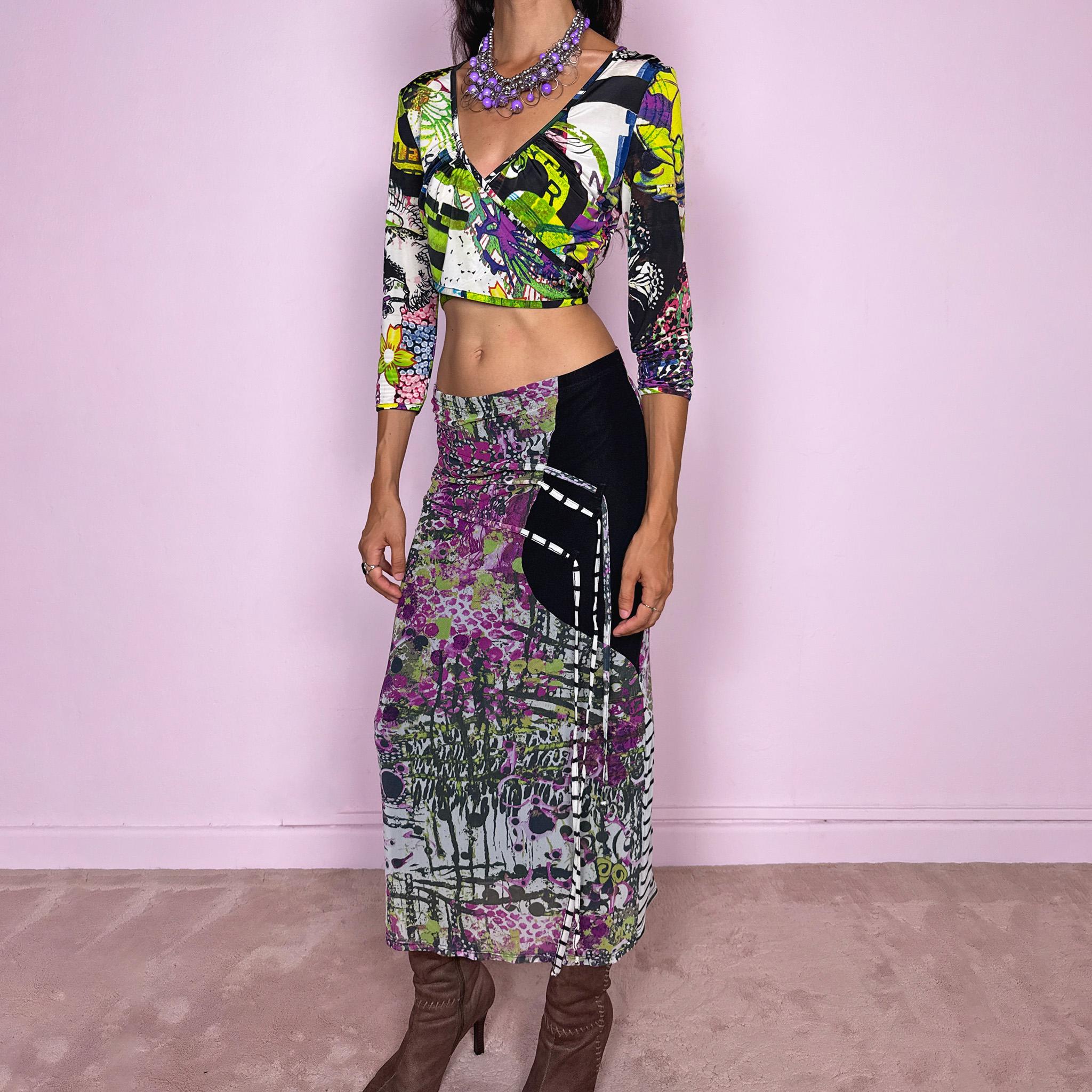 Vintage 2000s two-piece set featuring a fitted wrap-style crop top and matching printed midi skirt. The top has three-quarter sleeves, a deep V-neckline, and an adjustable tie-back closure. The matching skirt is made from stretchy mesh with an elasticated waist and abstract graphic print, featuring ruched detailing through the hip and decorative trailing straps for an asymmetric, deconstructed finish. It can be worn mid- to low-rise.