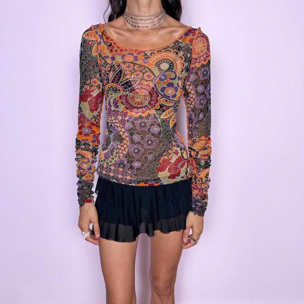 Vintage 2000s semi-sheer printed top featuring a fitted, stretchy silhouette with an intricate floral and paisley-inspired print in warm orange, burgundy, olive, brown, and muted purple tones. Designed with a wide scoop neckline and dramatic ruched long sleeves for a playful, maximalist art-to-wear aesthetic. Made in France by a French brand from 100% polyester. Excellent vintage condition.