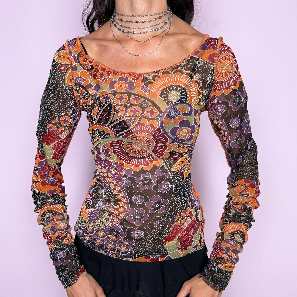 Vintage 2000s semi-sheer printed top featuring a fitted, stretchy silhouette with an intricate floral and paisley-inspired print in warm orange, burgundy, olive, brown, and muted purple tones. Designed with a wide scoop neckline and dramatic ruched long sleeves for a playful, maximalist art-to-wear aesthetic. Made in France by a French brand from 100% polyester. Excellent vintage condition.