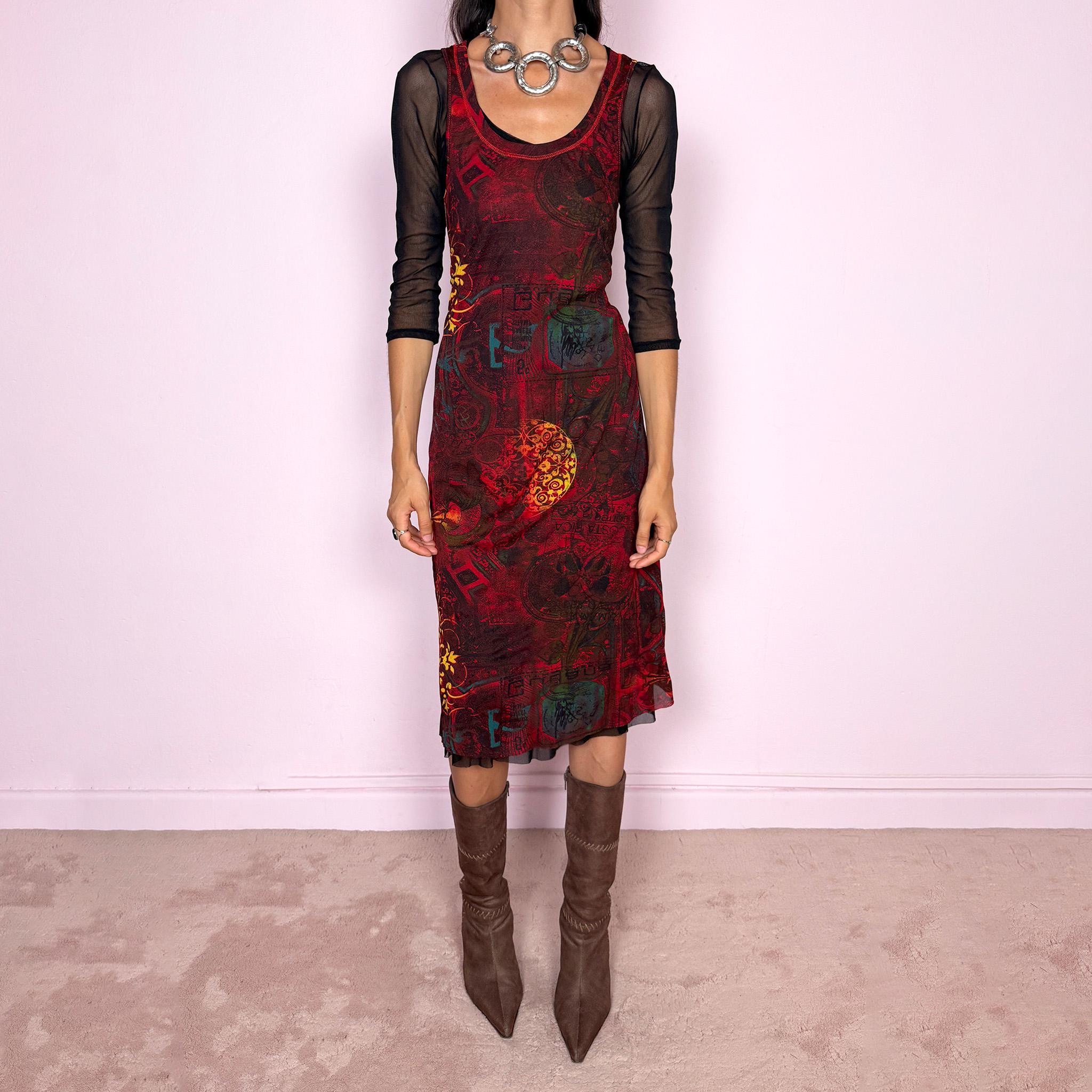 Vintage 2000s layered mesh midi dress, designed as a two-piece dress set that can be worn together or separately. The outer dress is sleeveless and stretchy, featuring a deep burgundy, red, and black graphic print with abstract ornamental motifs, while the inner layer is a sheer black mesh dress with 3/4 sleeves and a ruffled hem. A very versatile art-to-wear Y2K piece with dark maximalist layered transparency from a French brand.