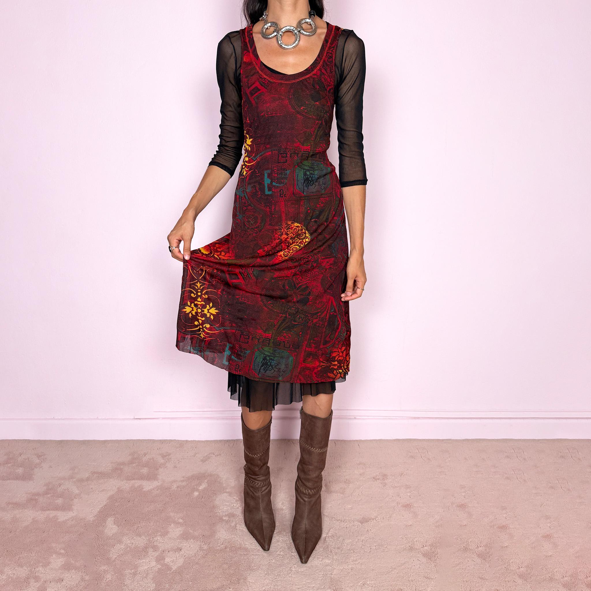Vintage 2000s layered mesh midi dress, designed as a two-piece dress set that can be worn together or separately. The outer dress is sleeveless and stretchy, featuring a deep burgundy, red, and black graphic print with abstract ornamental motifs, while the inner layer is a sheer black mesh dress with 3/4 sleeves and a ruffled hem. A very versatile art-to-wear Y2K piece with dark maximalist layered transparency from a French brand.