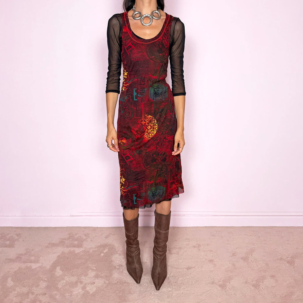 Vintage 2000s layered mesh midi dress, designed as a two-piece dress set that can be worn together or separately. The outer dress is sleeveless and stretchy, featuring a deep burgundy, red, and black graphic print with abstract ornamental motifs, while the inner layer is a sheer black mesh dress with 3/4 sleeves and a ruffled hem. A very versatile art-to-wear Y2K piece with dark maximalist layered transparency. From a French brand, made in France from 100% polyester. Excellent vintage condition.