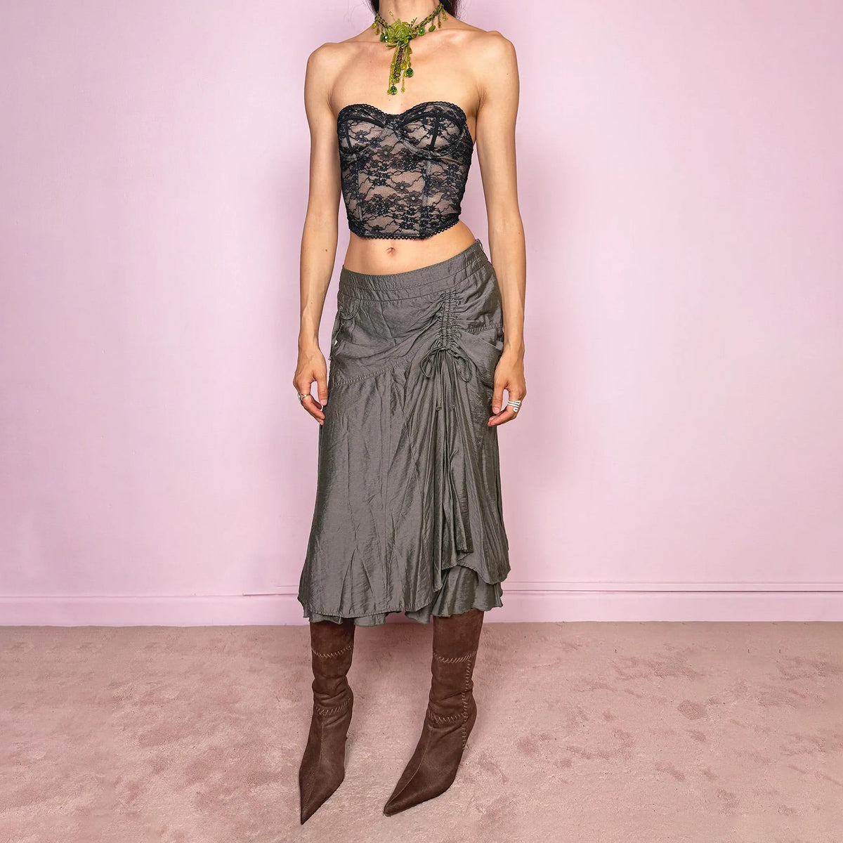 Vintage 2000s greenish-gray layered midi skirt featuring a fluid draped silhouette, ruched side detail with tie accents, and a softly flared layered hem. Designed in a non-stretch 83% viscose-blend fabric with a side zip closure and full polyester lining, the skirt has an avant-garde deconstructed aesthetic. Can be worn high-waisted for size L or lower-rise for M. Great vintage condition.