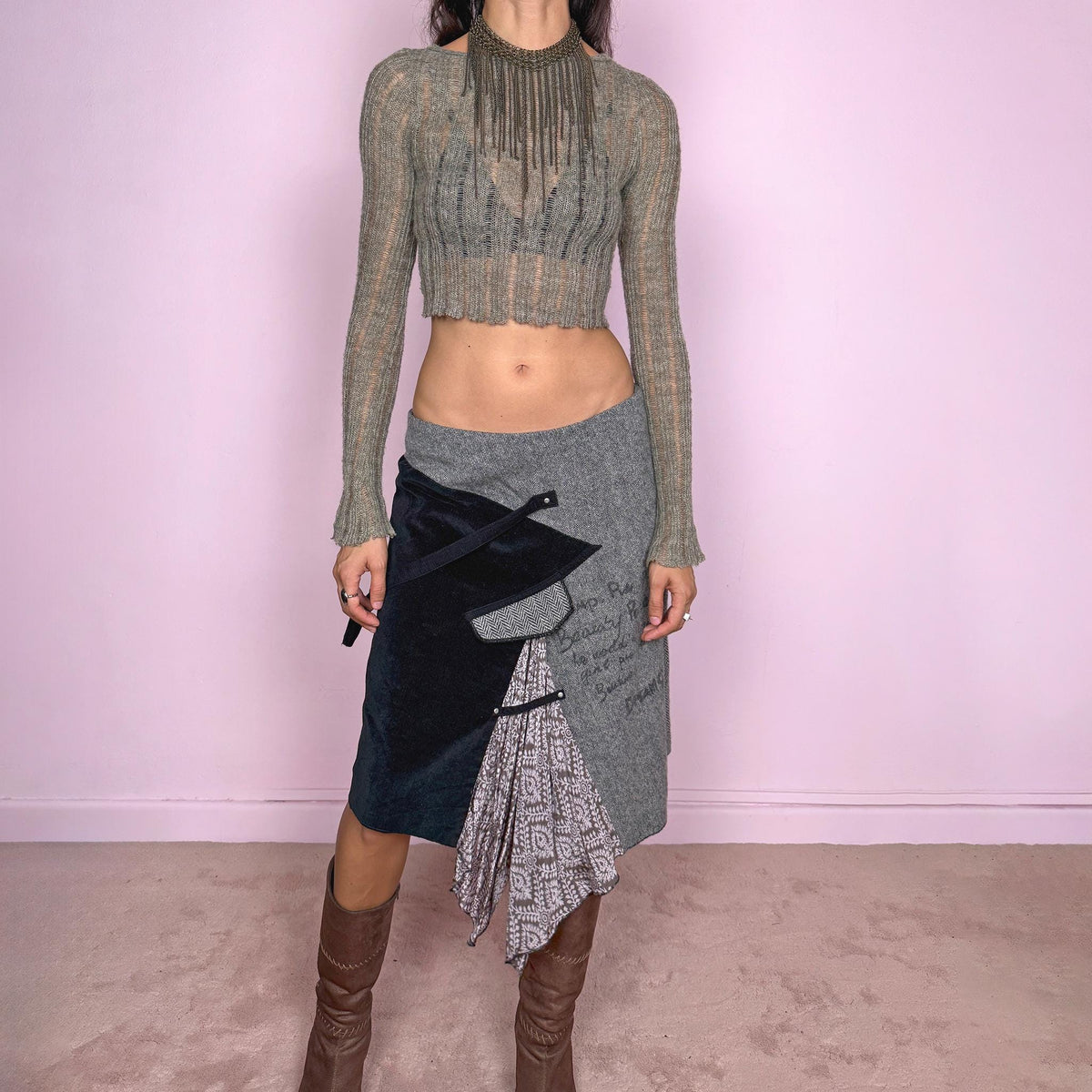 Vintage 2000s gray and black asymmetric midi skirt featuring contrasting textured panels, including a black corduroy panel with decorative corduroy straps, handwritten-style graphic detailing, and a printed insert that falls into a draped handkerchief point. Designed with a back zip closure and no stretch. Can be worn high-waisted for size L or lower on the waist for size M. From a French brand.