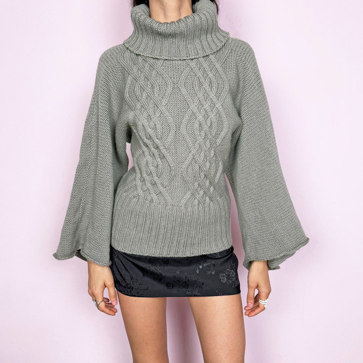 Vintage 2000s light khaki green grayish 100% pure new wool cable knit sweater featuring a chunky texture, an oversized turtleneck, and wide long sleeves. Crafted from thick, high-quality wool for warmth and a refined feel, making it a standout staple for colder seasons. Made in England. Excellent vintage condition.