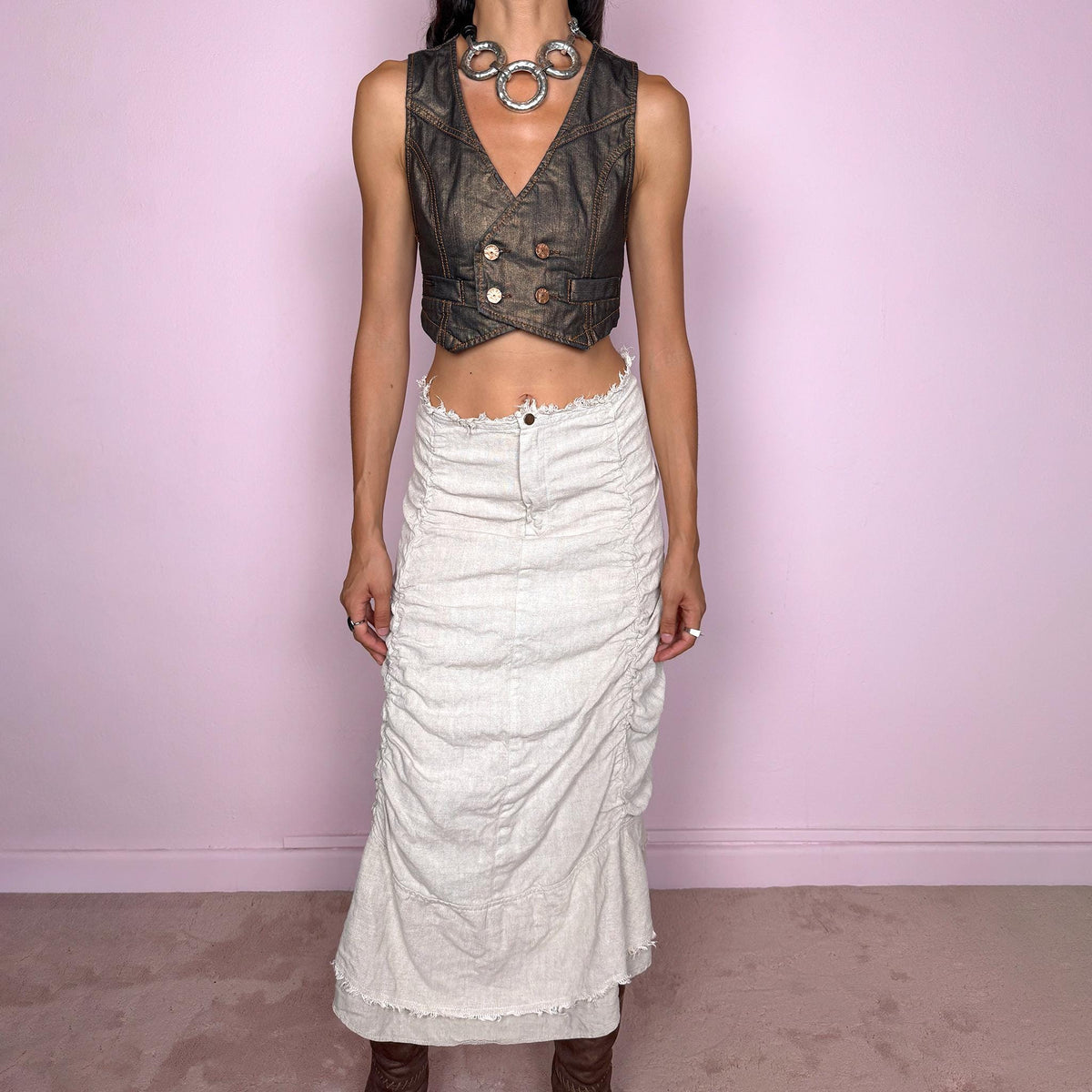 Vintage 2000s grayish off-white/light greige maxi skirt crafted from 100% linen, featuring sculptural ruched side detailing, softly gathered seams, and a flared layered hem with raw, frayed edges. The natural linen texture and muted earthy tone give it an avant-garde, rustic aesthetic. Non-stretch with a front zip closure. Can be worn high-waisted for size S or lower on the waist for size XS. Excellent vintage condition.
