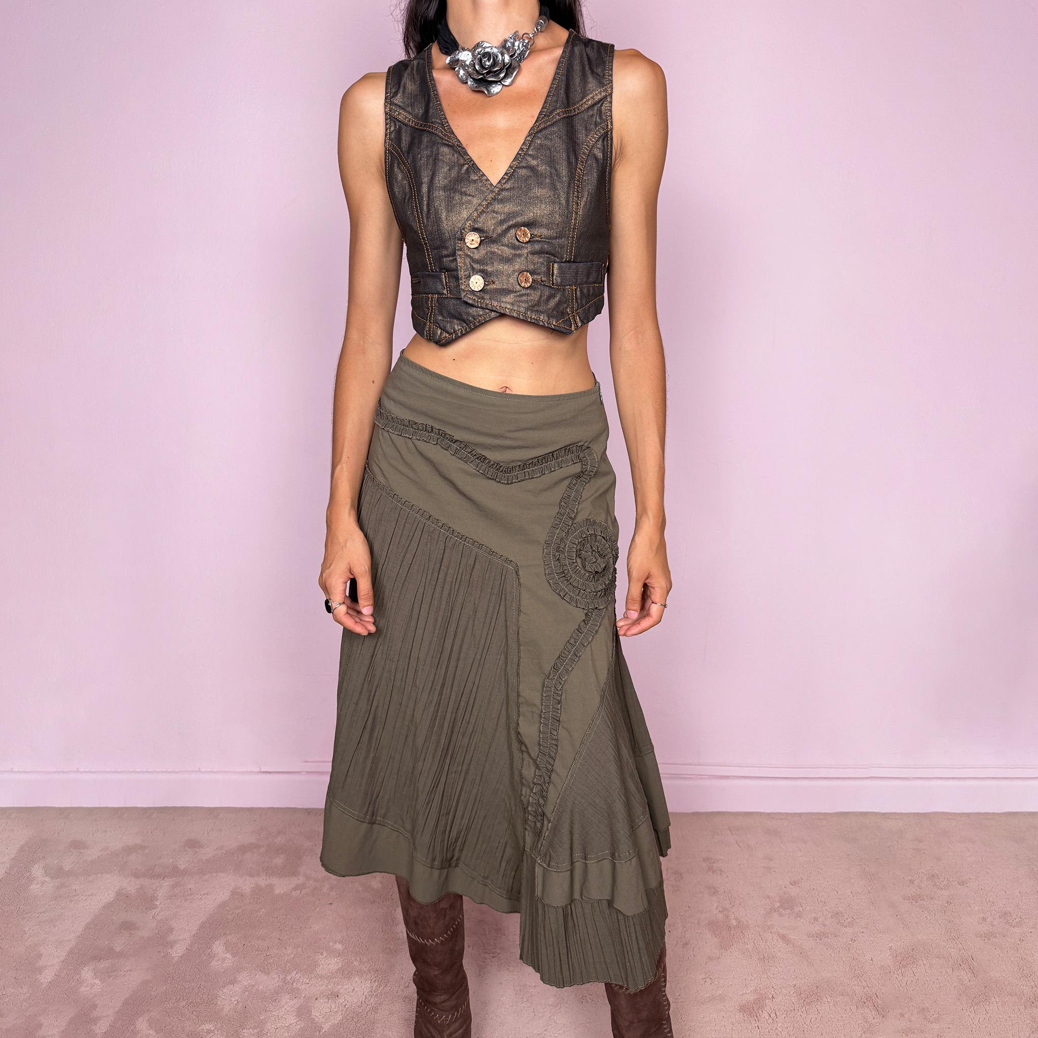 Vintage 2000s dark khaki asymmetric midi skirt designed with an irregular layered silhouette combining pleated panels, curved seam construction, sculptural ruffled appliqué detailing, a side zip closure, and a layered hem. Ideal for unique earthy fairy styling. Can be worn high-waisted for size S or lower on the waist for sizes XS–XXS. Made in France by a French brand from a non-stretch blend of 61% viscose and 39% polyamide. Great vintage condition.