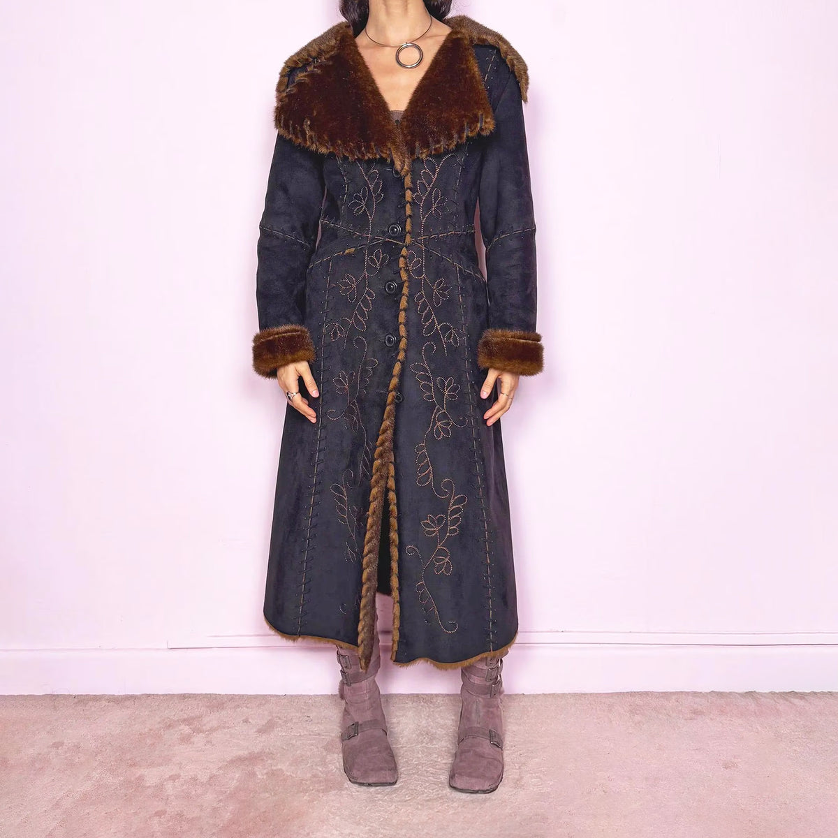 Stunning vintage 2000s dark gray, almost black, long penny lane coat from a French brand, featuring a warm brown faux-fur interior, oversized collar and matching cuffs. Designed in soft faux suede with intricate floral embroidery, practical pockets and a button-front closure. Perfect for whimsical fairycore, boho, forest muse and 70s Afghan-inspired styling. Made from polyester. Excellent vintage condition.