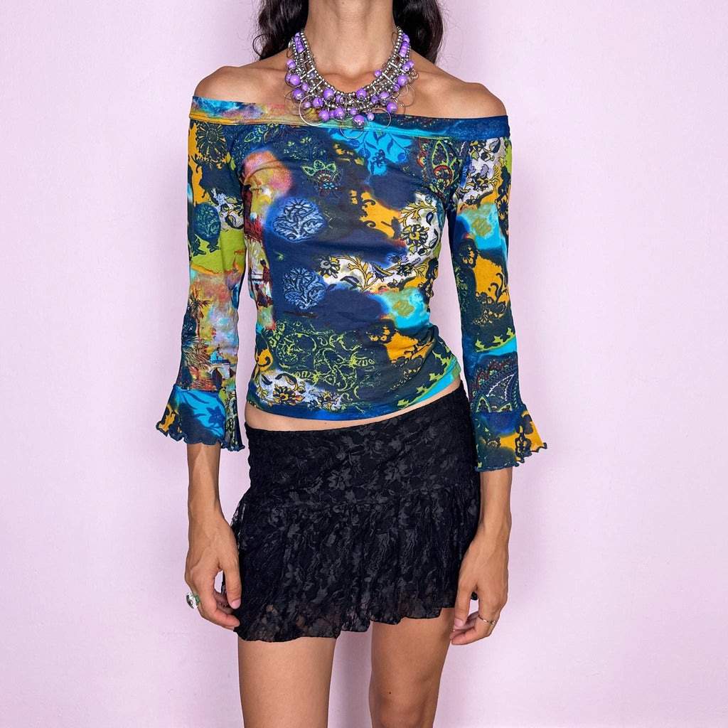 Vintage 2000s off-shoulder mesh top featuring a fitted, semi-sheer silhouette with a wide bateau neckline and flared three-quarter sleeves. Finished in a vivid mixed graphic print combining deep blue, turquoise, lime, yellow, and ornamental motifs for a maximalist bohemian Y2K look. Made in Italy by an Italian brand from 66% polyester and 34% polyamide. Excellent vintage condition.