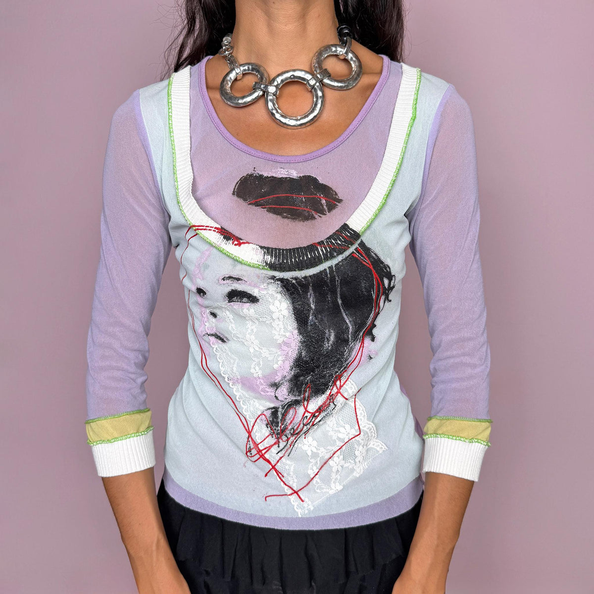 Vintage 2000s avant-garde top featuring a layered construction with 3/4 semi-sheer mesh sleeves, contrasting pastel lilac and pale blue tones, and an art-inspired painted graphic print with lace detailing across the front. Designed with a fitted silhouette, scoop neckline, and double-layer effect. A very unique Y2K art-to-wear piece. Made in France from a polyester and viscose blend. From a French brand. Excellent vintage condition.