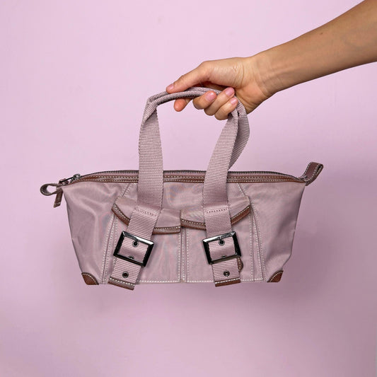 Vintage 2000s minimalist tech top handle bag in muted pink-lilac with structured utilitarian silhouette. Features zip closure, front pockets with snap buttons, dark metal buckles, and double top handles. Includes interior pockets. French design by Une Après-Midi de Chien Paris. Made from polyamide and nylon blend. Excellent vintage condition.