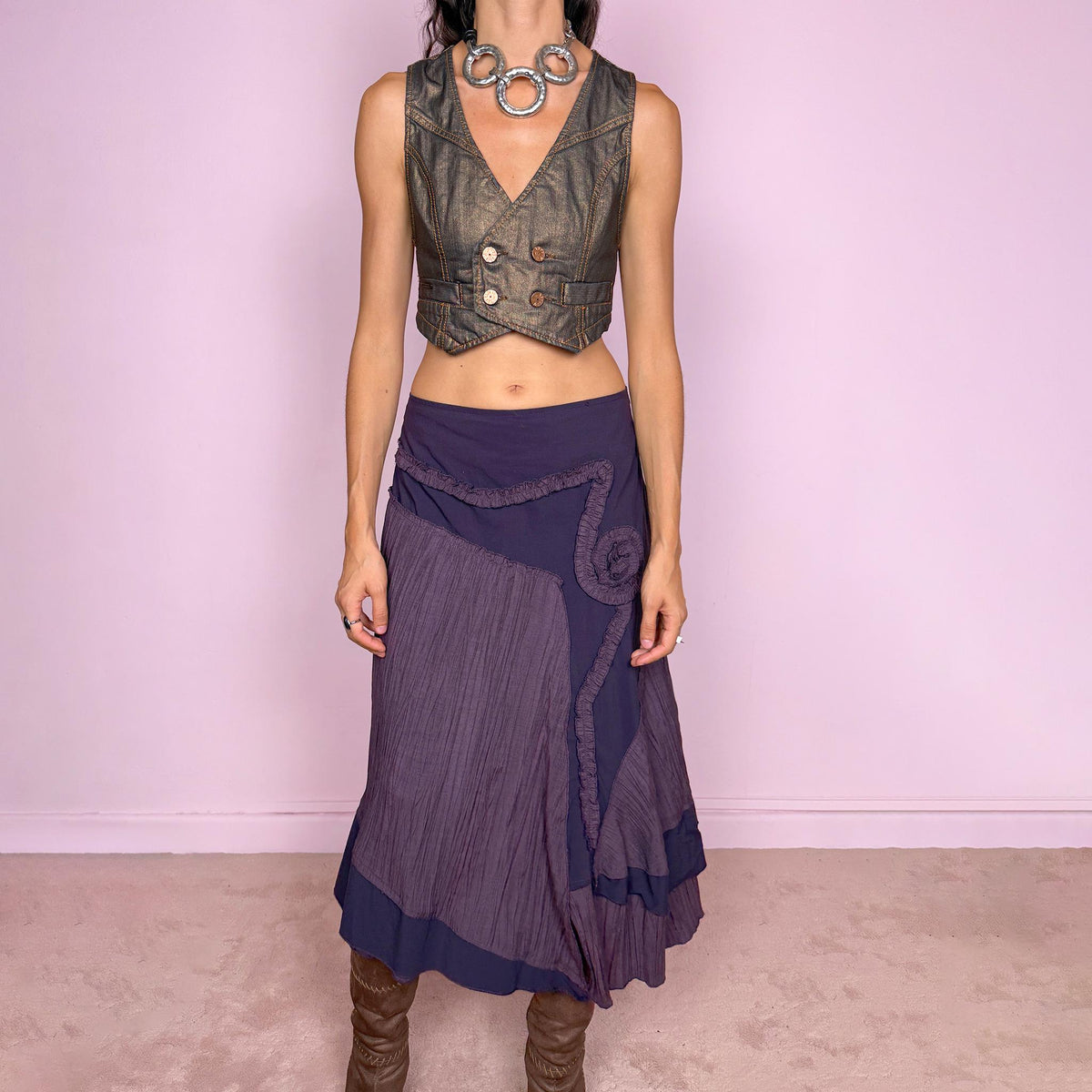 Vintage 2000s dark purple asymmetric midi skirt from a French brand, made in France. Features an irregular layered silhouette with contrasting pleated panels, curved seam construction, sculptural ruffled appliqué detailing, and a layered hem. Finished with a side zip closure. Can be worn high-waisted for size L or lower on the waist for sizes M–S.