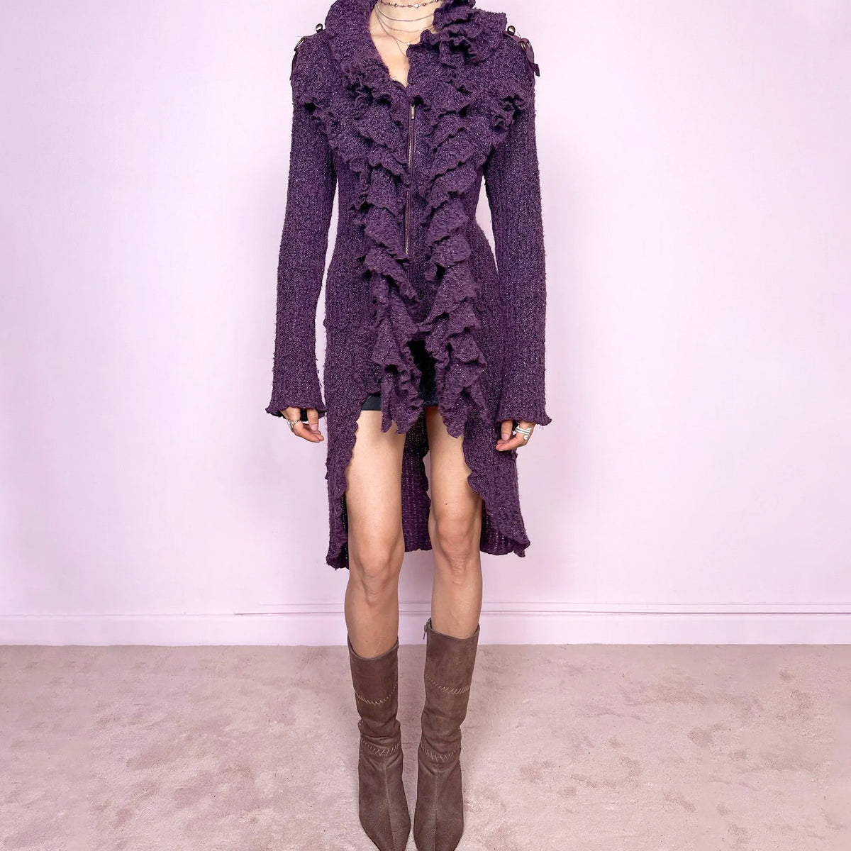 Vintage 2000s purple and black longline crazy cardigan with metallic thread, a zip-front closure, long bell sleeves, sculptural ruffle neckline, 3D cascading front ruffles, and an asymmetric high-low hem. Dramatic, extravagant, and bold for winter. Made by a French brand from an acrylic polyester blend. Great vintage condition.