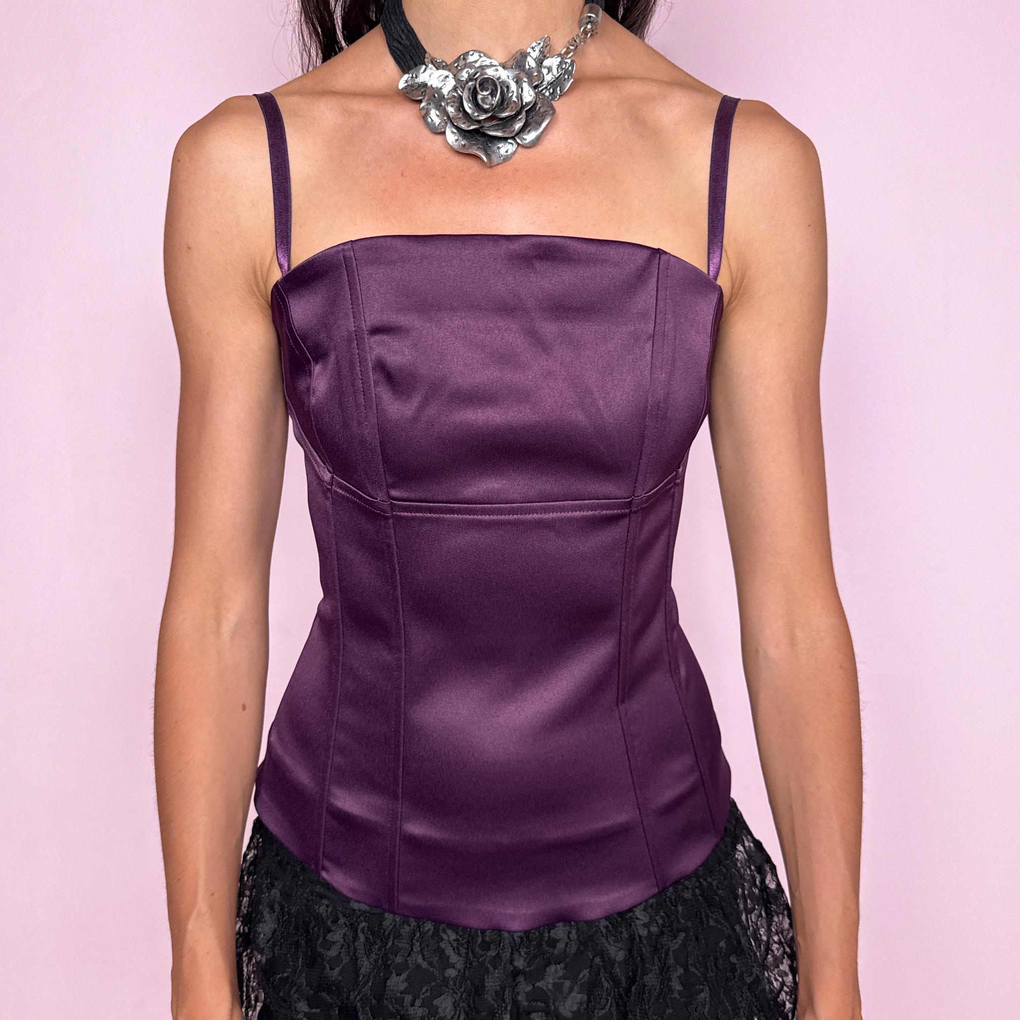 Vintage 2000s satin boned corset top in deep plum purple with a structured fitted silhouette, straight neckline, removable spaghetti straps, back zip closure, smooth satin finish, and subtle front panel detailing. Can be worn strapless, perfect for evening or formal occasions. Labels are missing, so fabric and brand are unknown. Excellent vintage condition.