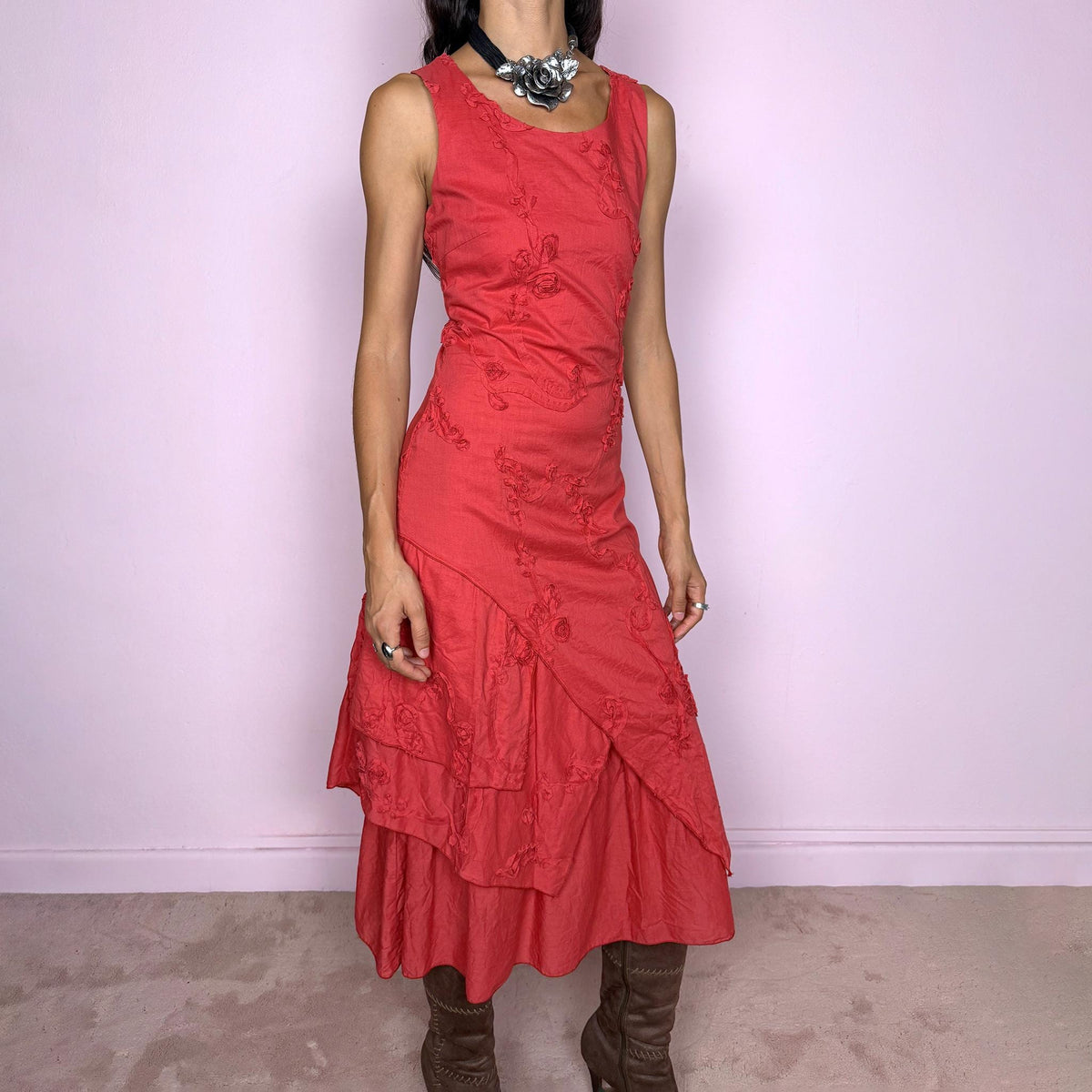 Vintage 2000s muted red midi dress featuring a fitted sleeveless bodice, subtle floral embroidery throughout, layered asymmetric paneling, and a softly flared tiered hem. Finished with a back zip closure. Non-stretch. The slightly faded brick-red tone, textured embroidery, and irregular layered construction give it a rustic, deconstructed aesthetic. Made in France from 100% cotton with a 100% polyester lining, from a French brand. Great vintage condition.