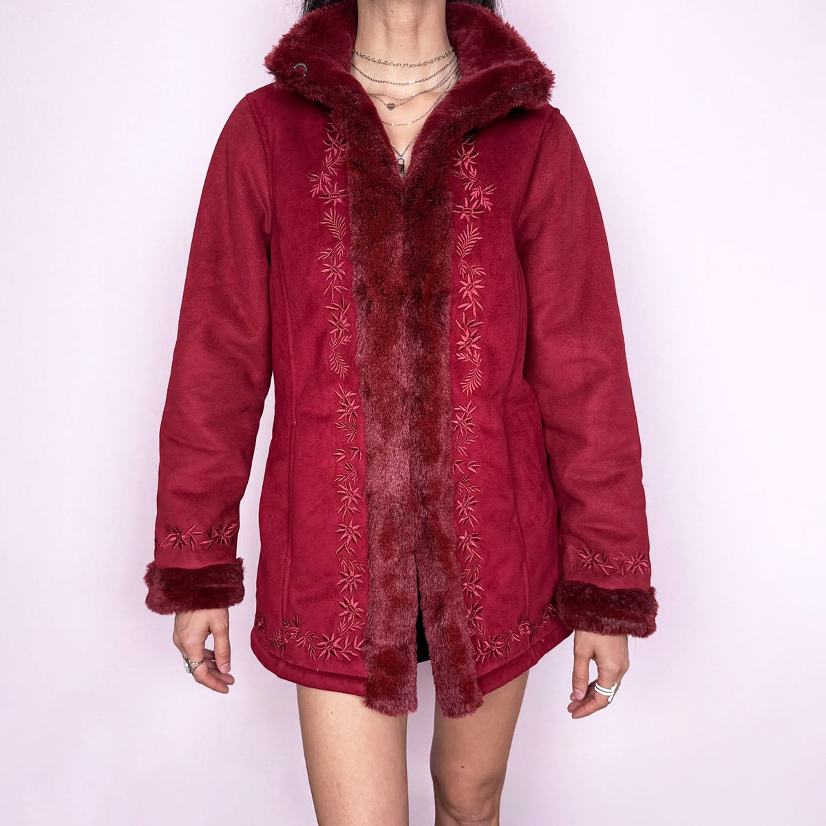 Vintage 2000s deep red Penny Lane-style coat with rich embroidery and plush faux-fur trim at the collar, cuffs, and interior. Cozy structured fit with pockets and a hook closure, creating a bold bohemian statement with a fairycore feel. Perfect for bold statement winter styling. Crafted from a polyester-acrylic blend. Excellent vintage condition.