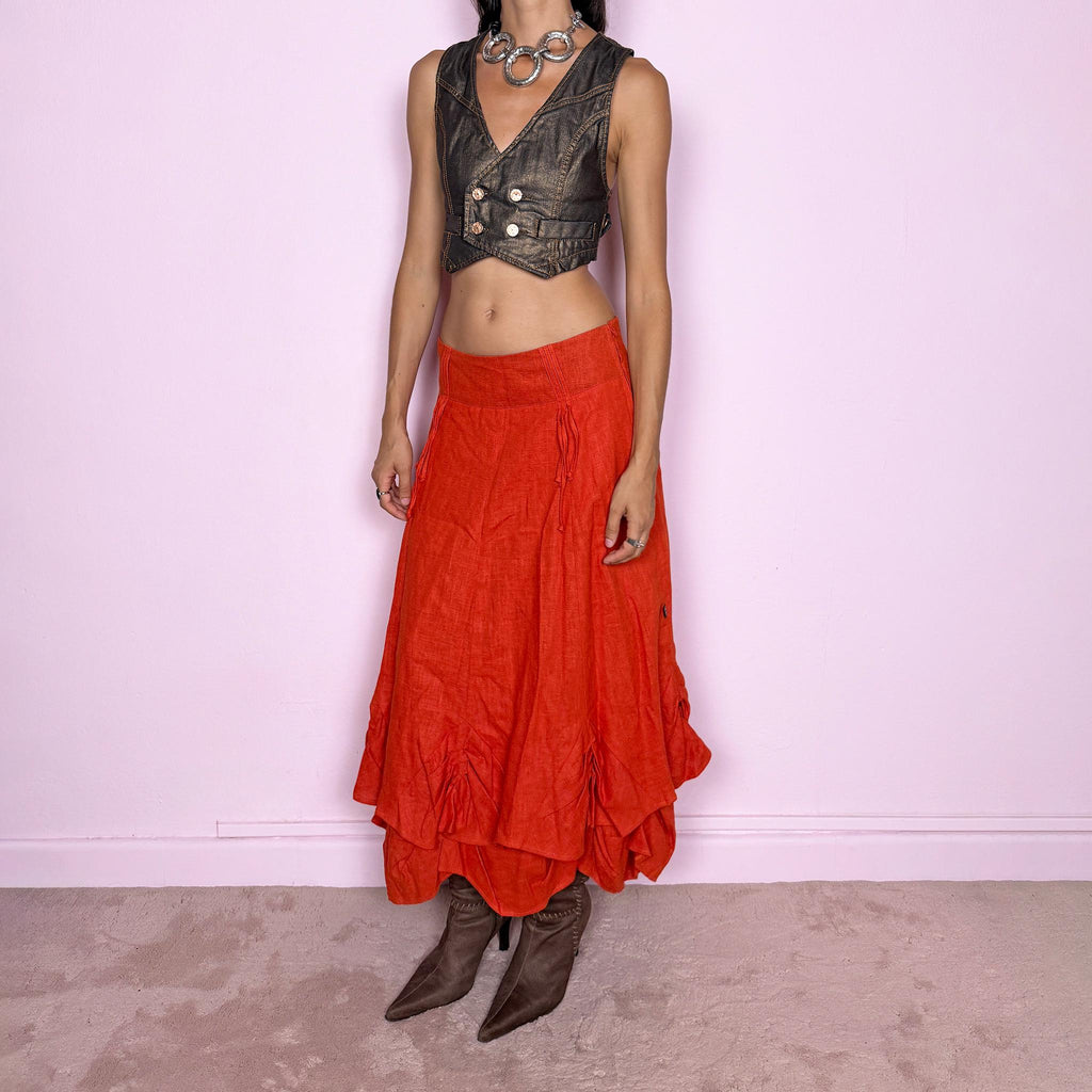 Vintage 2000s deconstructed red-orange linen layered maxi skirt featuring a side zip closure, flared silhouette, and layered construction with gathered, ruched, and draped detailing through the lower skirt. Non-stretch. Can be worn mid-rise on size S or slightly lower on the waist for XS. From a Dutch brand, crafted from 100% linen with a 100% polyester lining. Excellent vintage condition.