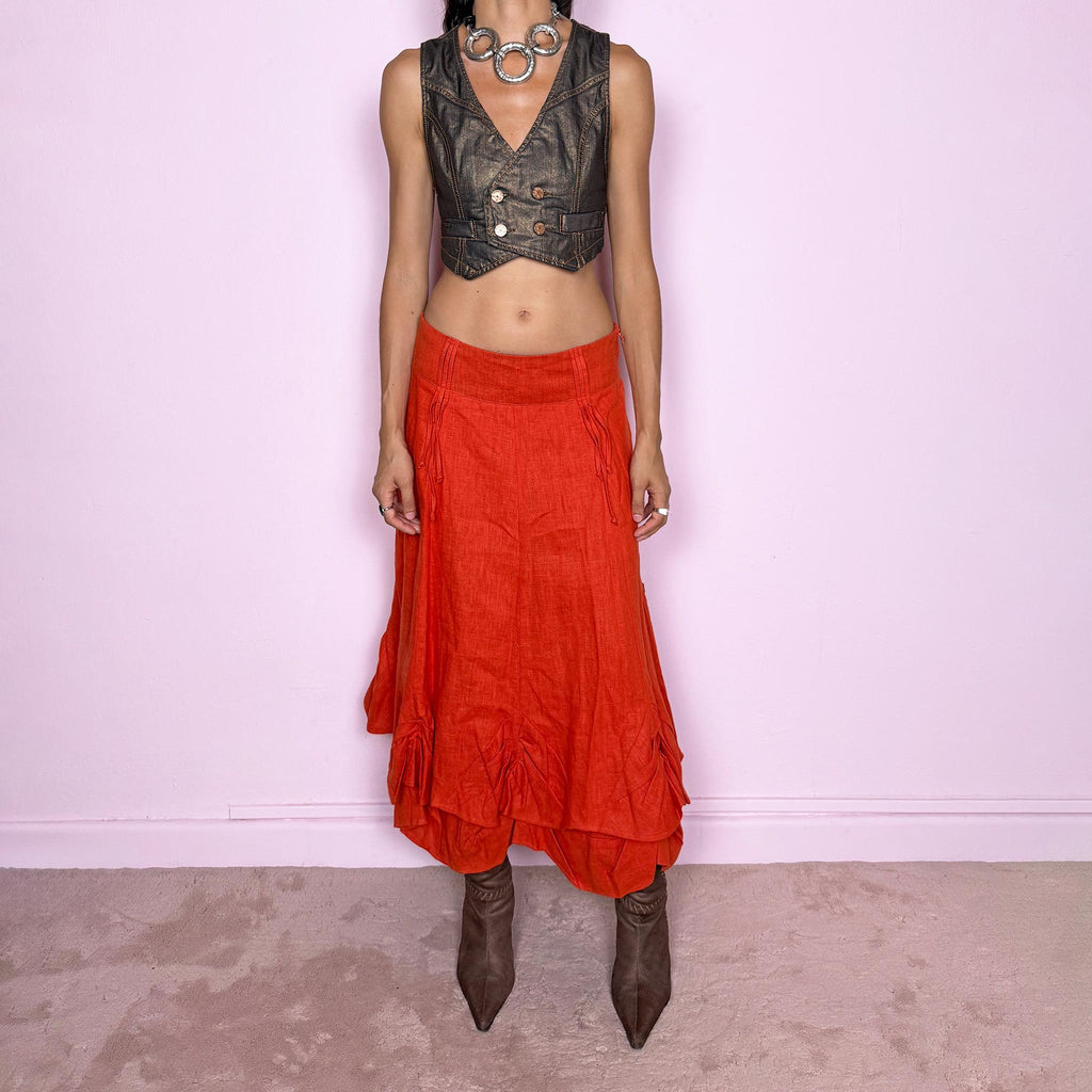 Vintage 2000s deconstructed red-orange linen layered maxi skirt featuring a side zip closure, flared silhouette, and layered construction with gathered, ruched, and draped detailing through the lower skirt. Non-stretch. Can be worn mid-rise on size S or slightly lower on the waist for XS. From a Dutch brand, crafted from 100% linen with a 100% polyester lining. Excellent vintage condition.