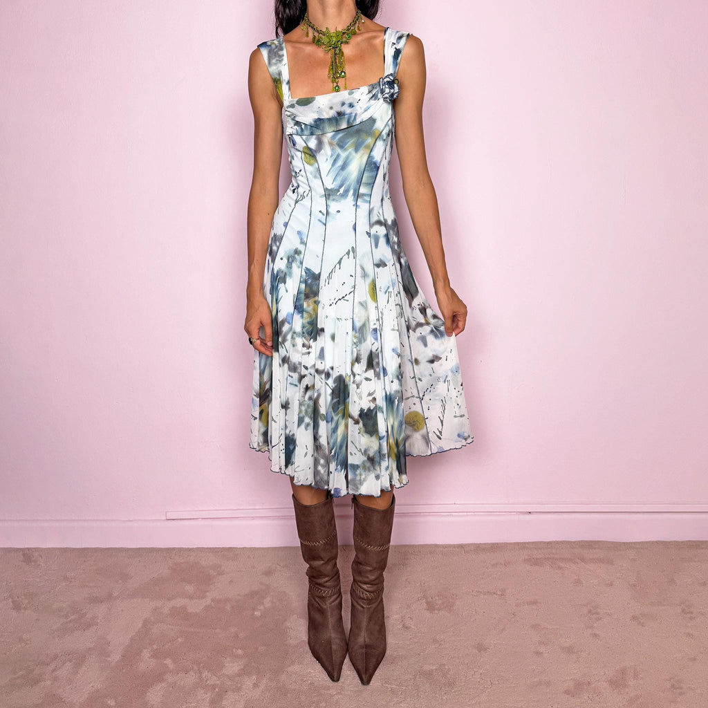 Vintage 2000s art-print midi dress featuring an abstract painterly graphic print in soft blue, gray, olive, and white tones, with a fitted bodice, square neckline, wide shoulder straps, and sculpted panel seams that open into a fluid flared skirt. Finished with a small rosette appliqué at the neckline. A distinctive Y2K art-to-wear piece. Made in the USA by an American brand from stretchy 100% polyamide mesh. Excellent vintage condition.