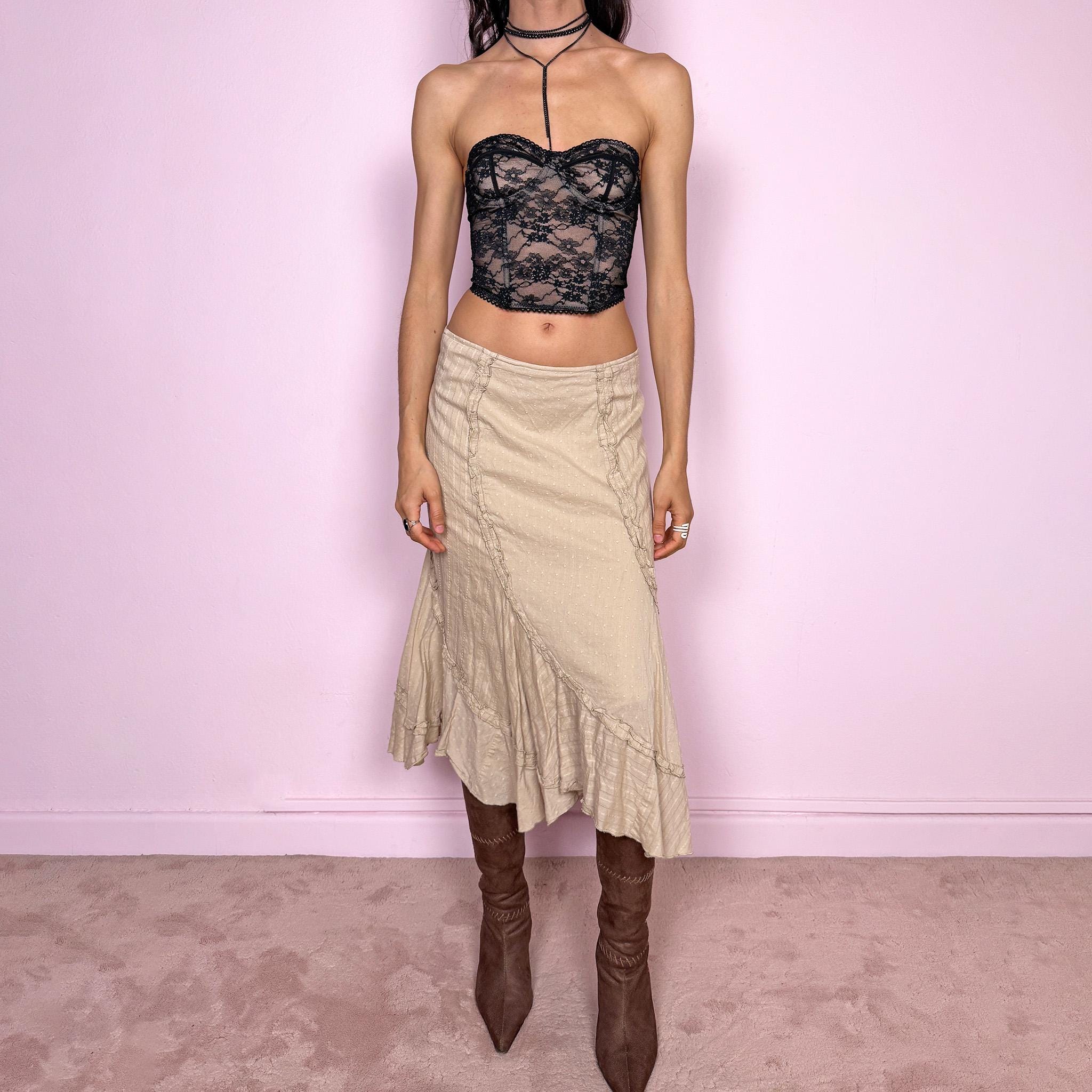 Vintage 2000s beige midi skirt with a soft boho fairycore feel. Features a flared asymmetric hem, paneled construction, and delicate ruffle gathered details throughout. Side zip closure with no stretch. Can be worn high waisted for size L or mid to low rise for size M. Made from 100% cotton. Great vintage condition.