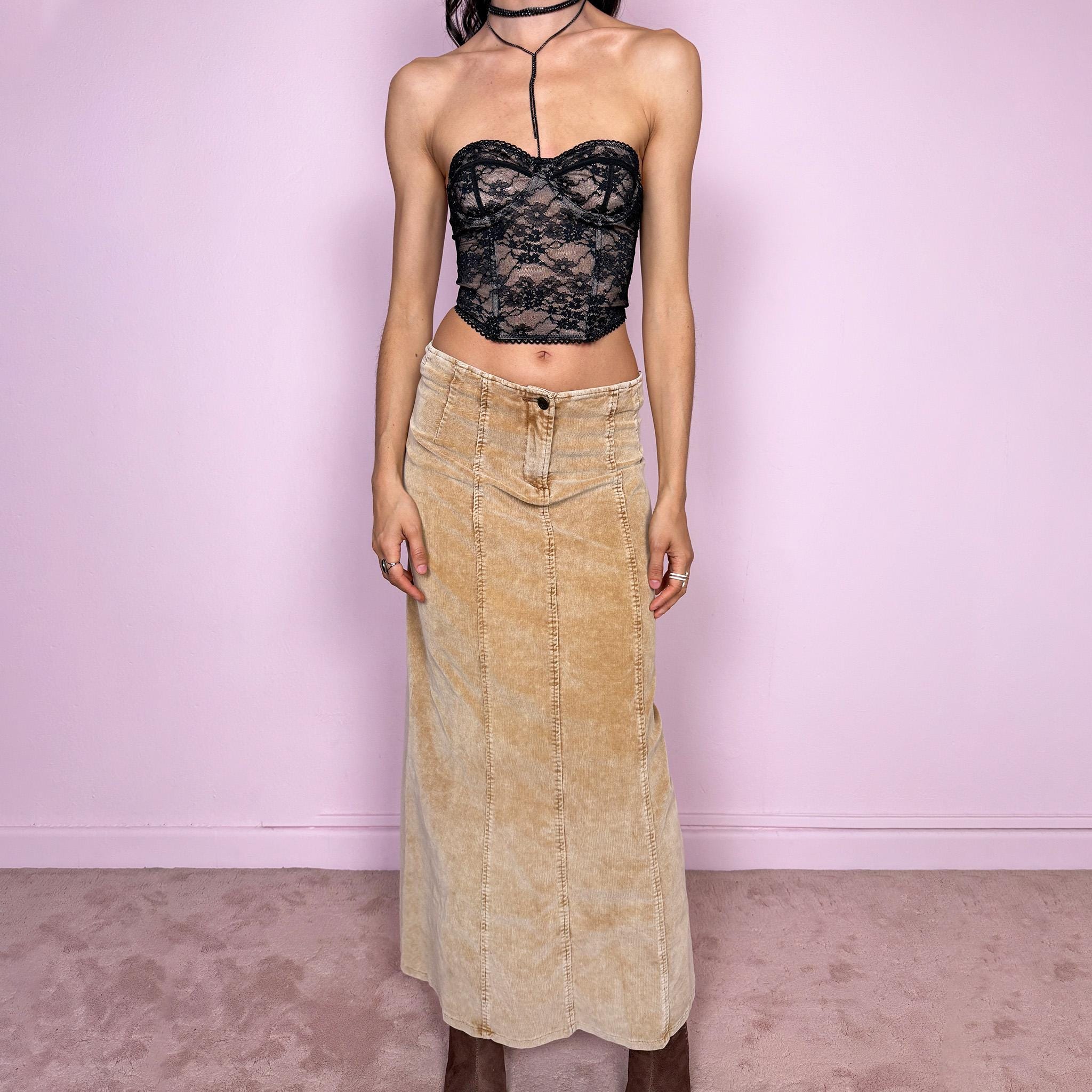 Vintage 2000s beige corduroy maxi skirt with a soft ribbed texture and indie grunge feel. Features a stretchy fitted silhouette with panelled seams and a front zip closure. Perfect for autumn winter layering. Can be worn mid to low rise for size XXS/XS. Excellent vintage condition.