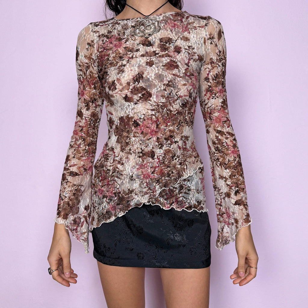 Vintage 2000s beige mesh lace top featuring a romantic brown and maroon floral print with soft glitter accents. Semi-sheer and stretchy with flared sleeves and an asymmetric hem. The fitted silhouette and delicate lace texture create an elegant yet dreamy fairycore aesthetic. Perfect for party nights, boho occasions, or any whimsical and ethereal styling. Excellent vintage condition.