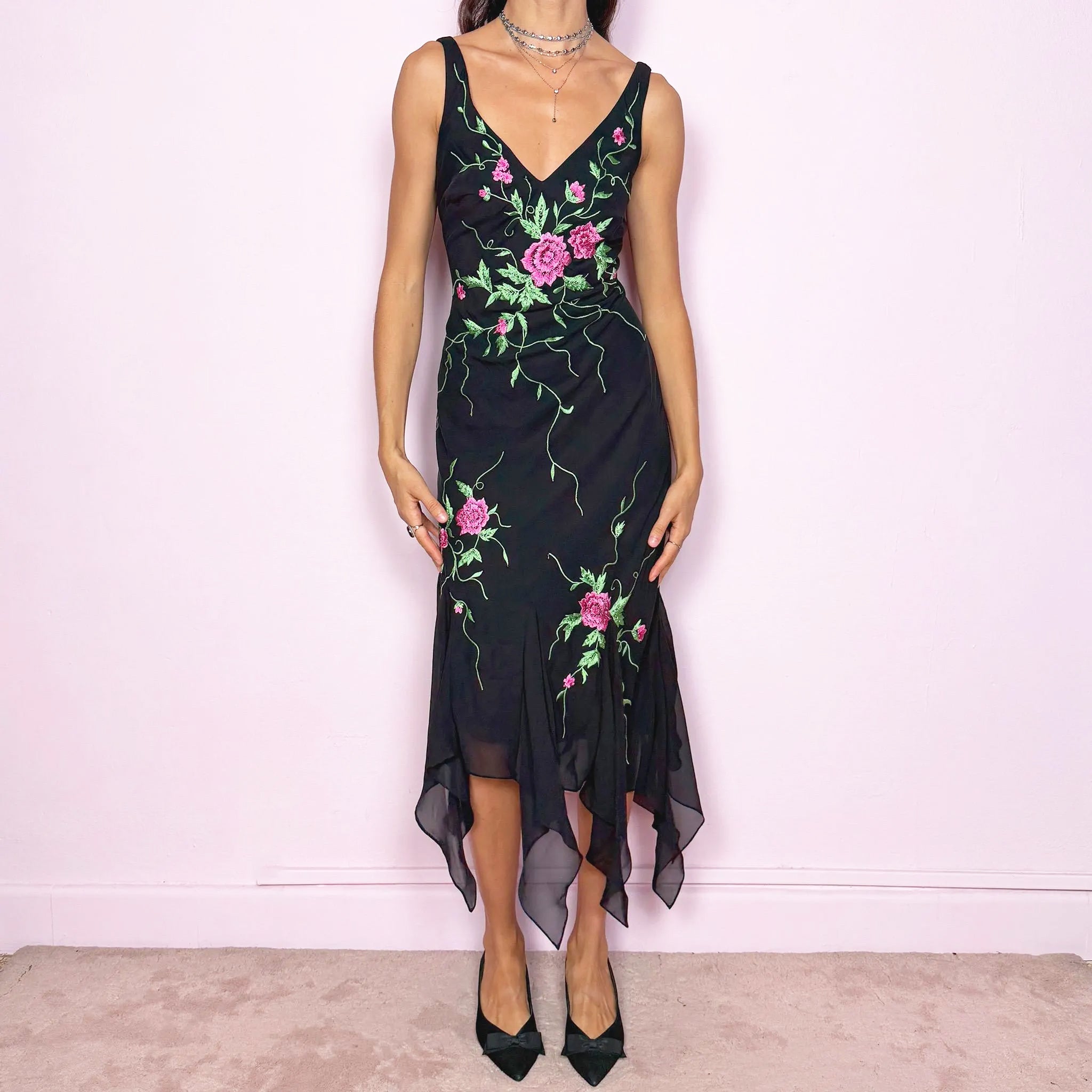 Stunning vintage 2000s black sleeveless V-neck long midi dress featuring pink and green floral embroidered details with beaded accents. The asymmetric handkerchief-style hem adds movement and a romantic statement look, perfect for gala events, formal parties or night occasions. Made from polyester. Excellent vintage condition.