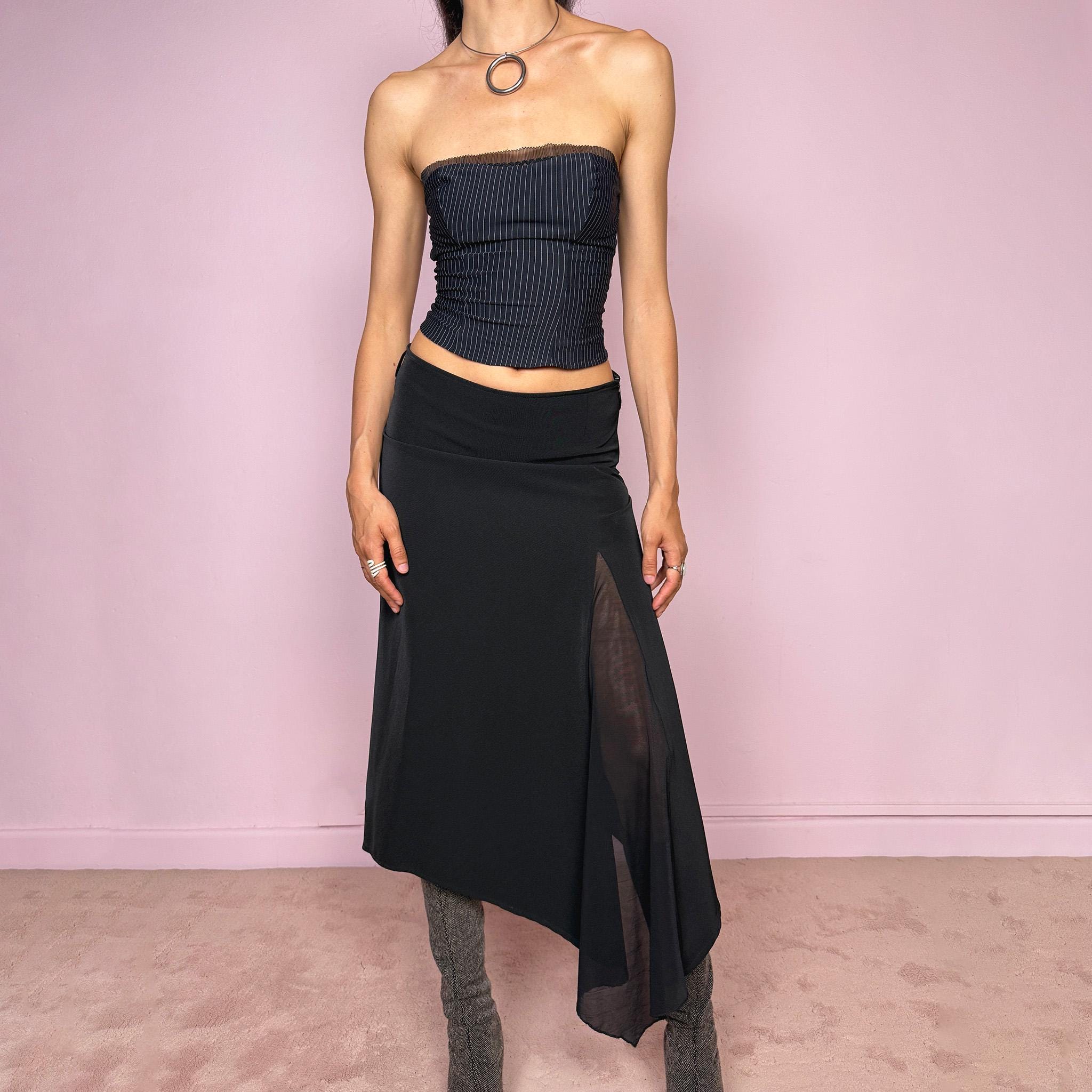 Vintage 2000s black midi skirt with an avant-garde deconstructed look. Features a pointed asymmetric hem, semi-sheer mesh panel detail, side zip closure, and a smooth no-stretch fit with a fluid draped silhouette. Perfect for dark styling and evening events. Can be worn high waisted for S or lower rise for XS/XXS. Made from a polyester elastane blend. Excellent vintage condition.