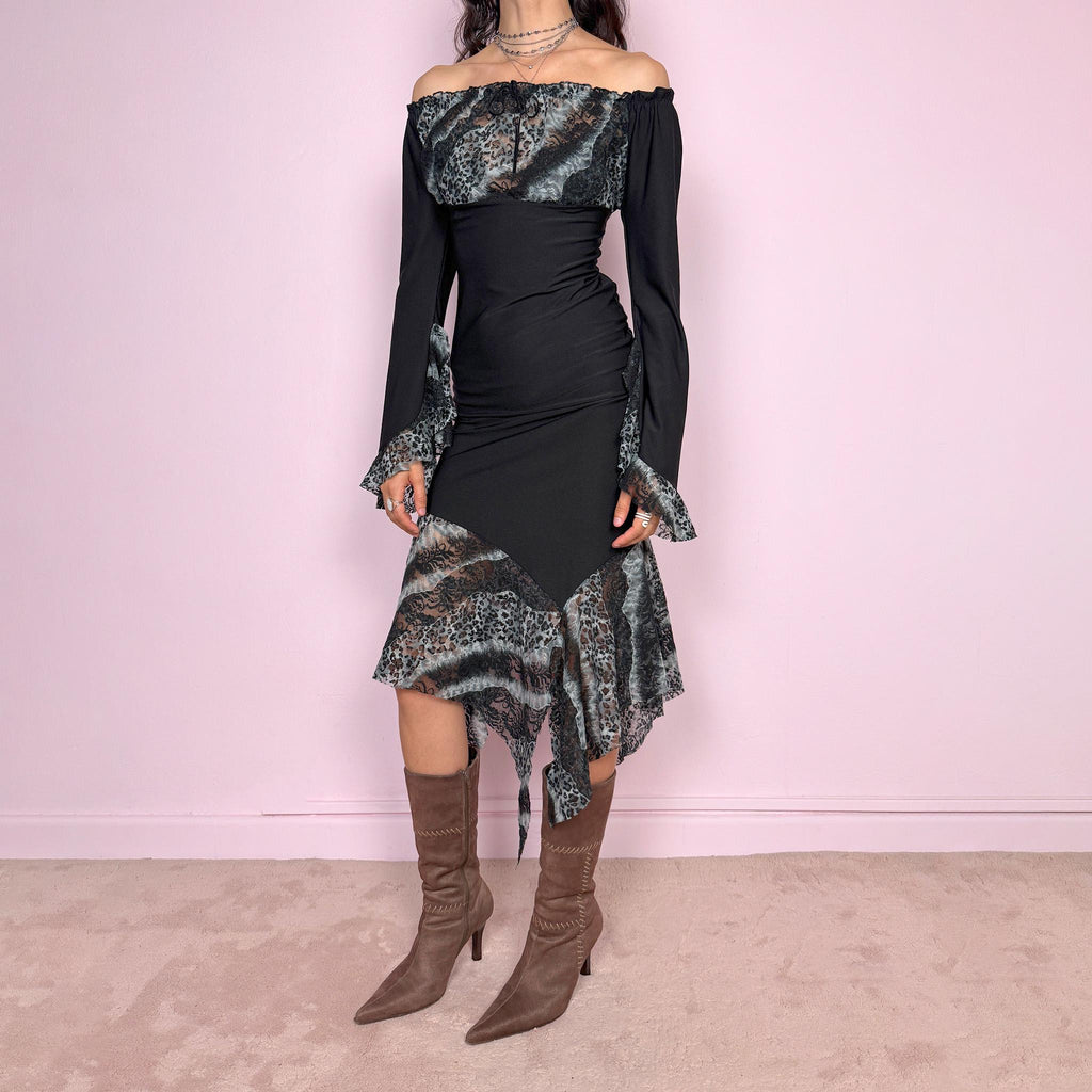 Vintage 2000s black two piece set with an elastic waist midi skirt, asymmetrical hem, and matching off shoulder blouse with 3/4 bell sleeves, ruffle cuffs, tie neckline, and semi-sheer gray leopard mesh bust panel. Whimsical dark fairy look. Made in France from a polyester elastane blend. Excellent vintage condition.