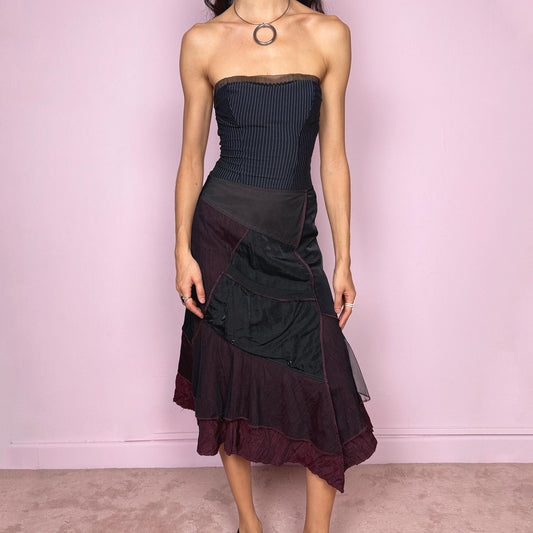 Vintage 2000s dark deconstructed avant garde black paneled midi skirt with a mesh tulle asymmetrical hem and unique design. Features a back zip closure, front pocket, and structured no-stretch fabric for a sculpted fit. Can be worn mid rise for XXS/XS or high-waisted for S. Dystopian grunge futuristic aesthetic. Made in France by a French brand from a polyamide, polyester, and viscose blend. Excellent vintage condition.