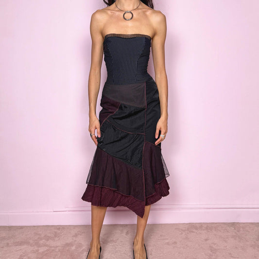 Vintage 2000s dark deconstructed avant garde black paneled midi skirt with a mesh tulle asymmetrical hem and unique design. Features a back zip closure, front pocket, and structured no-stretch fabric for a sculpted fit. Can be worn mid rise for XXS/XS or high-waisted for S. Dystopian grunge futuristic aesthetic. Made in France by a French brand from a polyamide, polyester, and viscose blend. Excellent vintage condition.