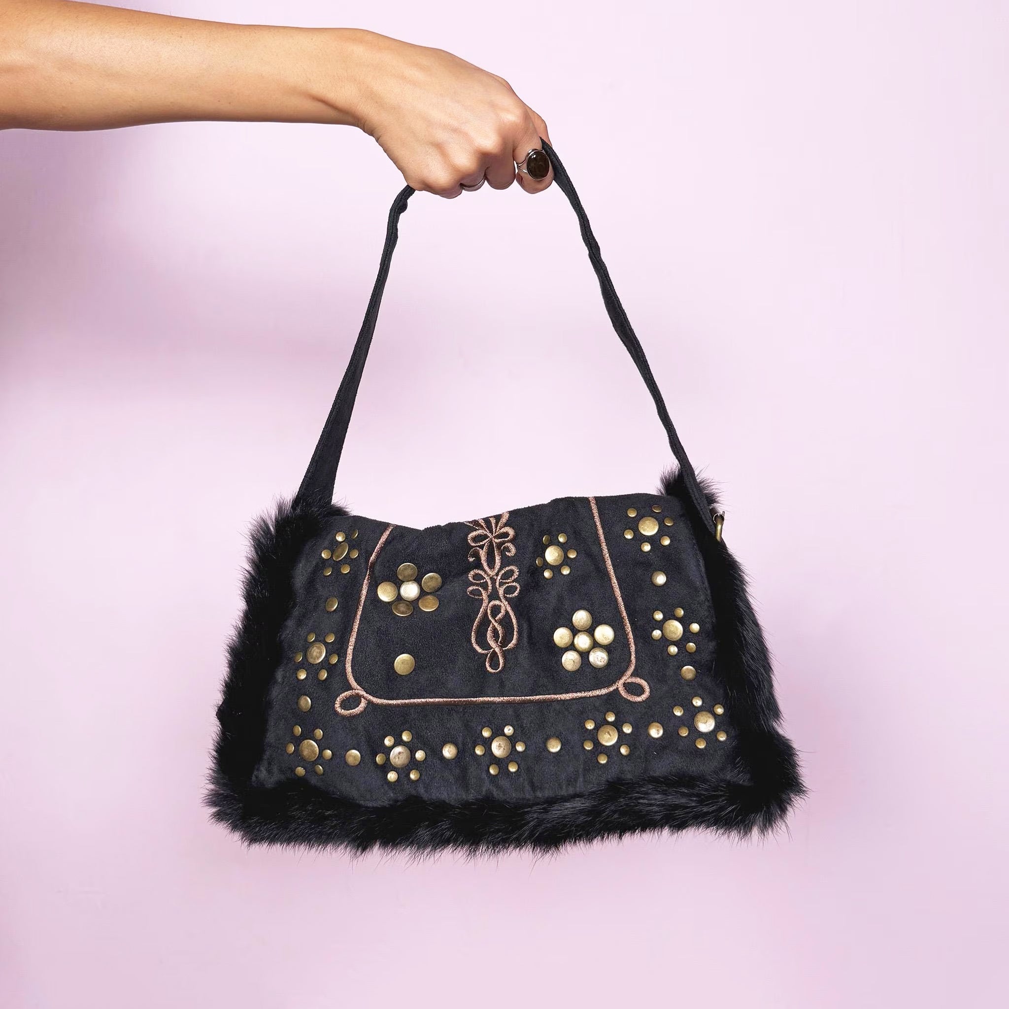 Vintage 2000s dark gray-almost-black shoulder bag featuring soft faux suede and corduroy with black faux fur trim along the flap. The front showcases golden round studded details and brown embroidered accents for a bold boho look. It has a zipper closure and a comfortable shoulder strap, making it a super cute party or night-out statement piece. Designed in France. Excellent vintage condition.