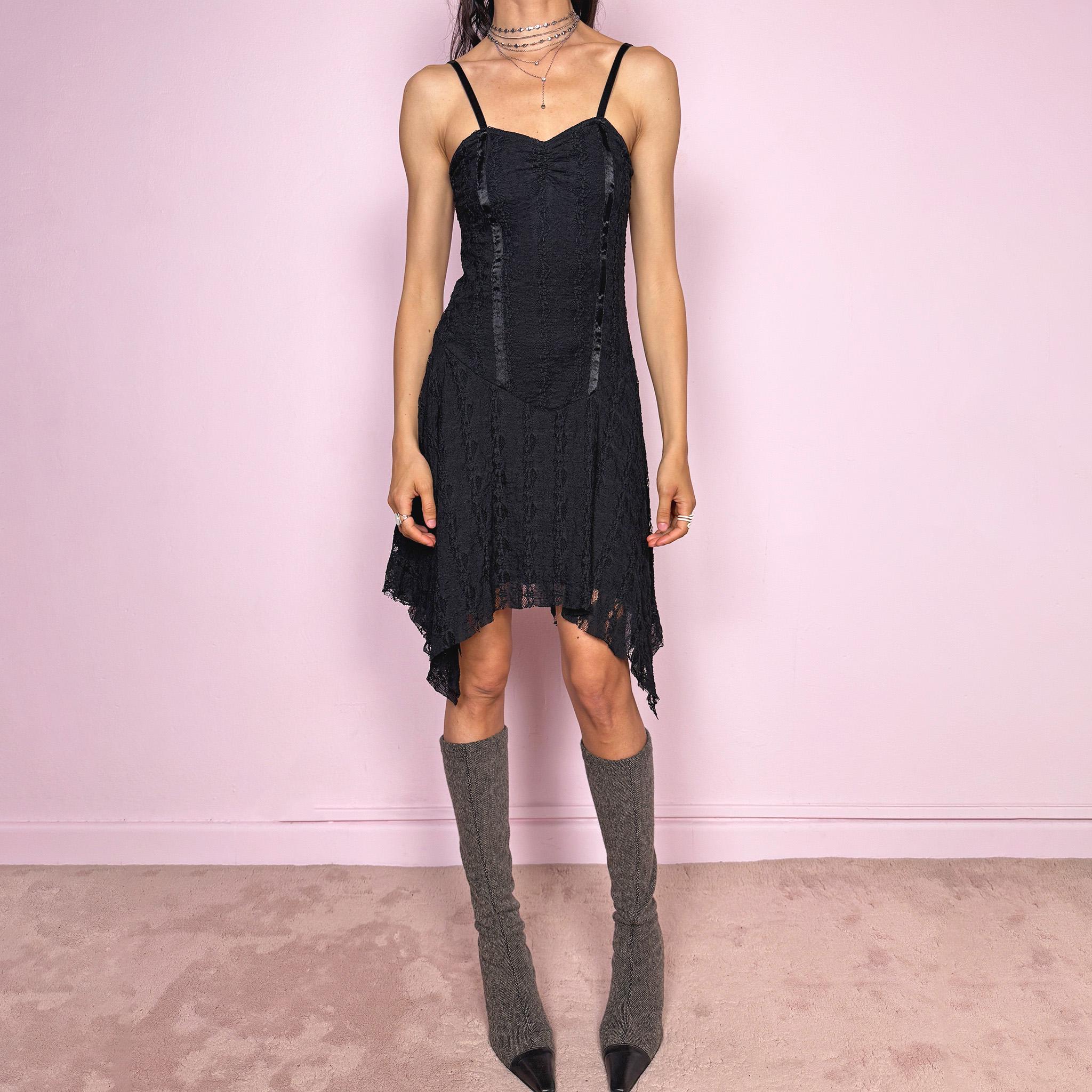 Vintage 2000s whimsical fairy goth black lace midi dress with a fitted body-skimming silhouette and adjustable straps. Features delicate sheer lace texture and an asymmetrical handkerchief hem. Perfect for night parties, festivals or dark romantic styling. Made in the UK from a polyester elastane blend. Great vintage condition.