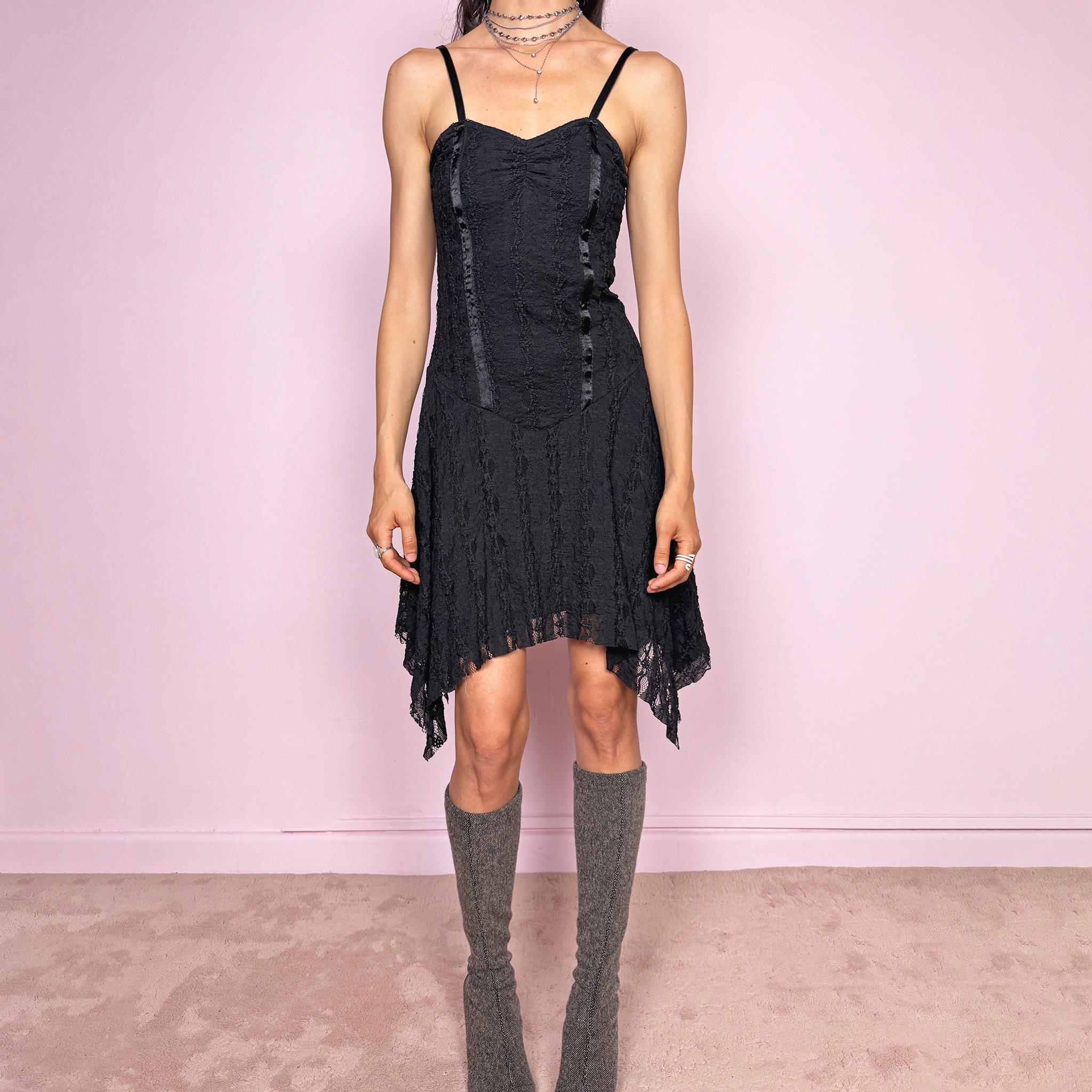 Vintage 2000s whimsical fairy goth black lace midi dress with a fitted body-skimming silhouette and adjustable straps. Features delicate sheer lace texture and an asymmetrical handkerchief hem. Perfect for night parties, festivals or dark romantic styling. Made in the UK from a polyester elastane blend. Great vintage condition.