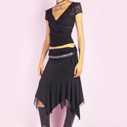The Y2K Black Layered Asymmetric Skirt is a vintage 2000s piece featuring an avant-garde design. It has intricate bead detailing on the waist and adjustable ruched side ties. The skirt includes mesh sheer layers and a handkerchief-style asymmetric hemline, making it perfect for a bold night out look.