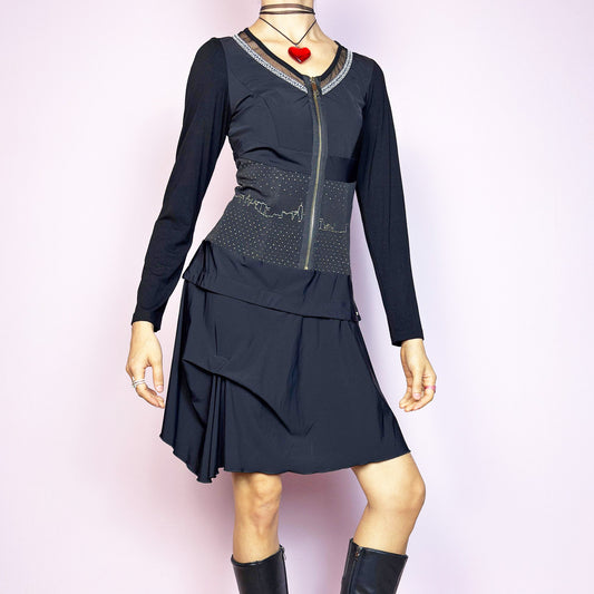 The Y2K Black Long Sleeve Mini Dress is a vintage 2000s sleek and deconstructed mini dress featuring a fitted bodice with a front zipper and a glittery cityscape detail at the waist. The long sleeves balance the edgy vibe of the layered, asymmetrical skirt, giving it a sculptural silhouette. Stretchy and comfortable, this dress is perfect for cybercore and futuristic clubwear. Great vintage condition.