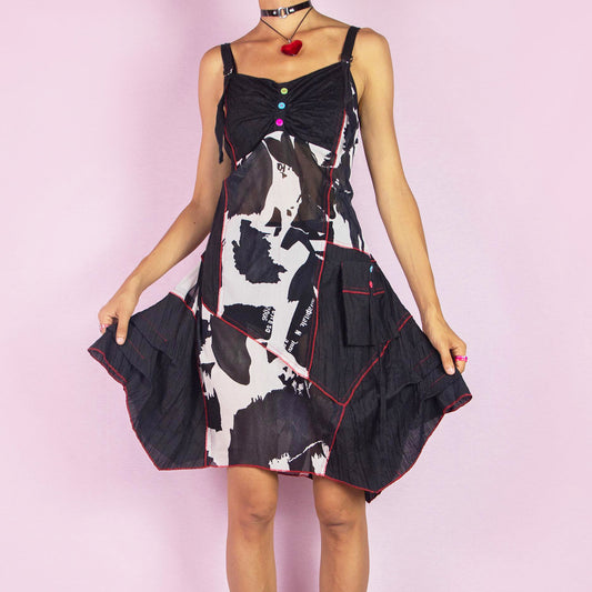 The Y2K Black Mesh Asymmetric Dress is a bold vintage 2000s piece featuring a unique patchwork design with contrast red stitching and colorful button detailing on the front. Made from sheer mesh fabric with adjustable straps, this dress has a playful asymmetrical hemline and patch pockets. Perfect for festivals, parties, or summer casual outings. Great vintage condition.