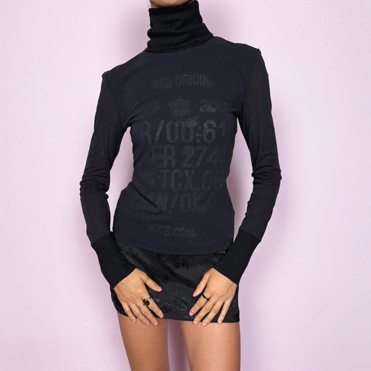 Vintage 2000s black mesh sheer long sleeve top with a ribbed knit turtleneck and ribbed cuffs, featuring a subtle text lettering print visible through the underlayer. Stretchy and fitted with a cyber-futuristic and minimalist feel, ideal for streetwear, grunge outfits, and autumn layering. Made from a polyester wool polyamide blend. Excellent vintage condition.