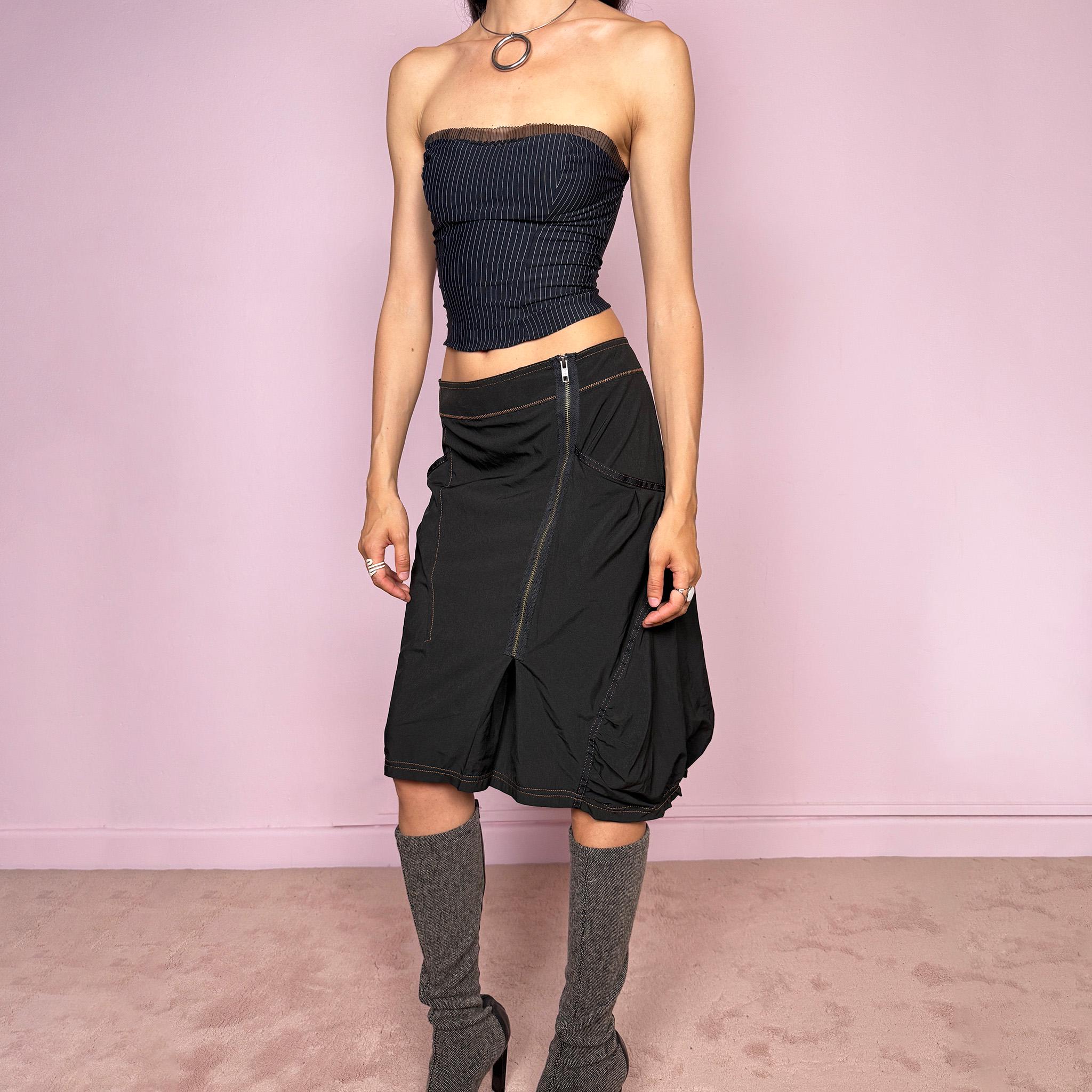 Vintage 2000s lightweight black midi skirt with a dark avant-garde dystopian techwear look. Features pockets, an asymmetric front zip closure, ruched details, contrast topstitching, and a bubble hem effect. No stretch. Can be worn mid rise for size L or lower rise for size M. Great vintage condition.