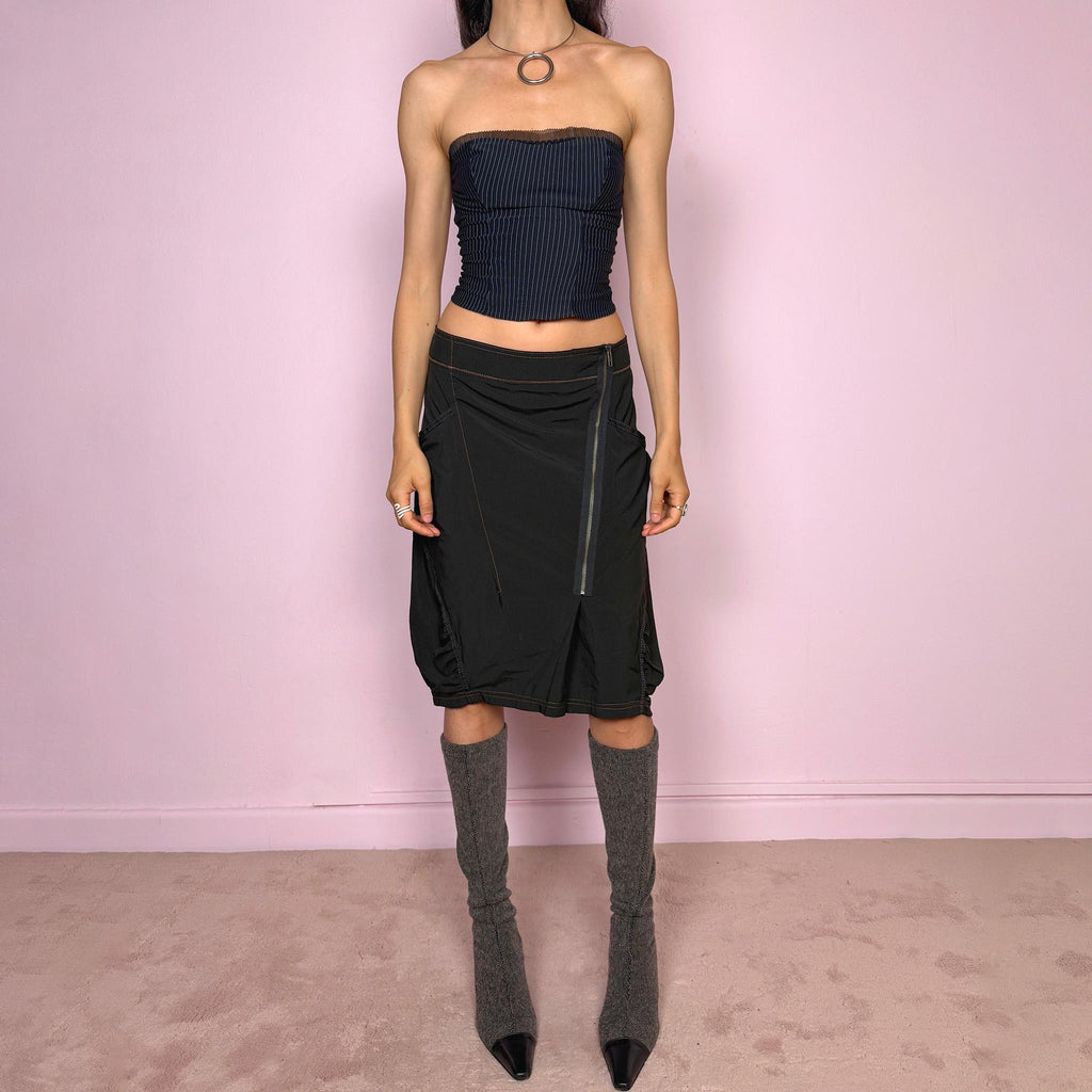 Vintage 2000s lightweight black midi skirt with a dark avant-garde dystopian techwear look. Features pockets, an asymmetric front zip closure, ruched details, contrast topstitching, and a bubble hem effect. No stretch. Can be worn mid rise for size L or lower rise for size M. Great vintage condition.