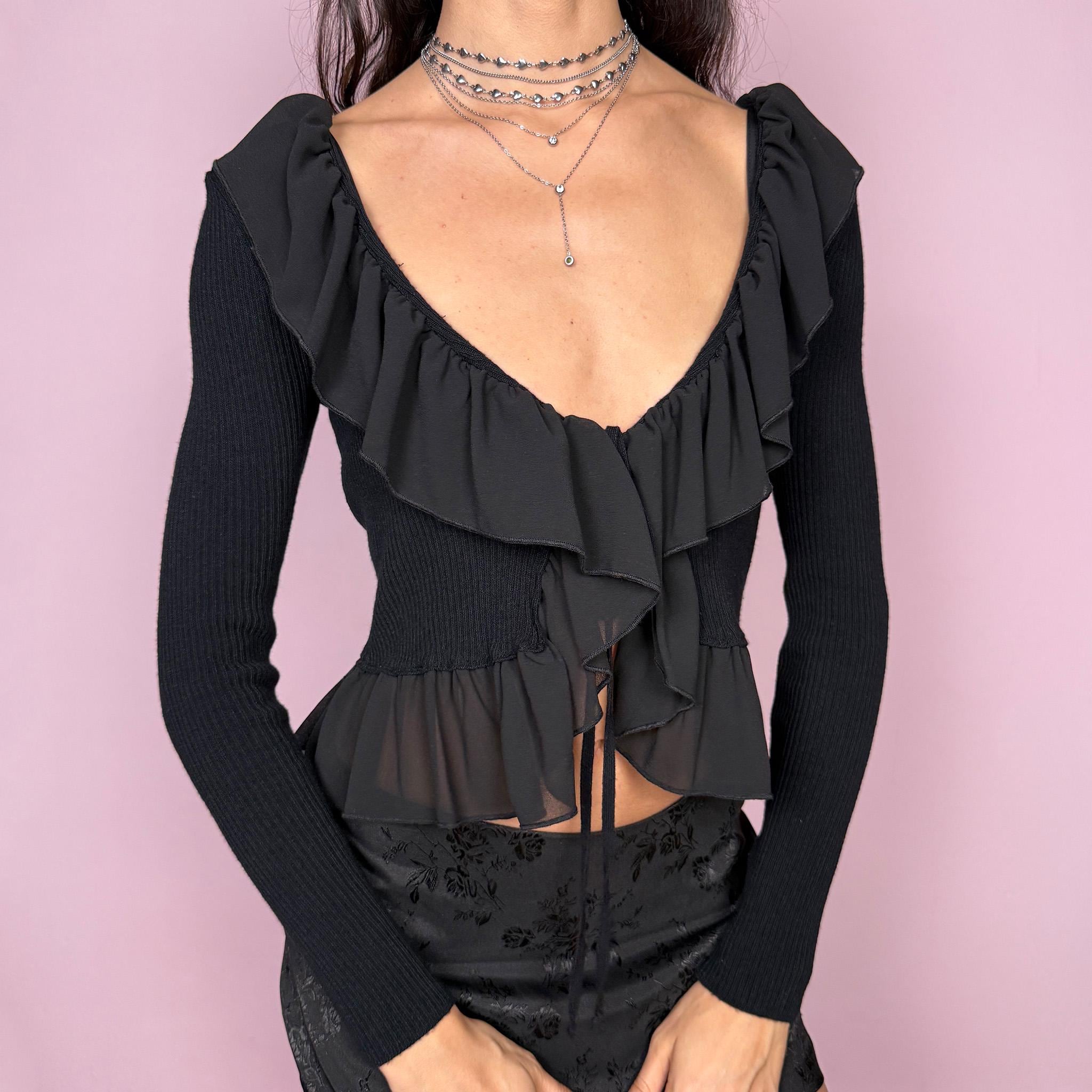 Dark romance vintage 2000s black ribbed knit long sleeve tie-front cropped cardigan with ruffle neckline and hem. Feminine coquette goth bolero style layering jacket with a stretchy fit. Made in Italy by an Italian brand from Polyamide, Polyester, and Viscose. Excellent vintage condition.