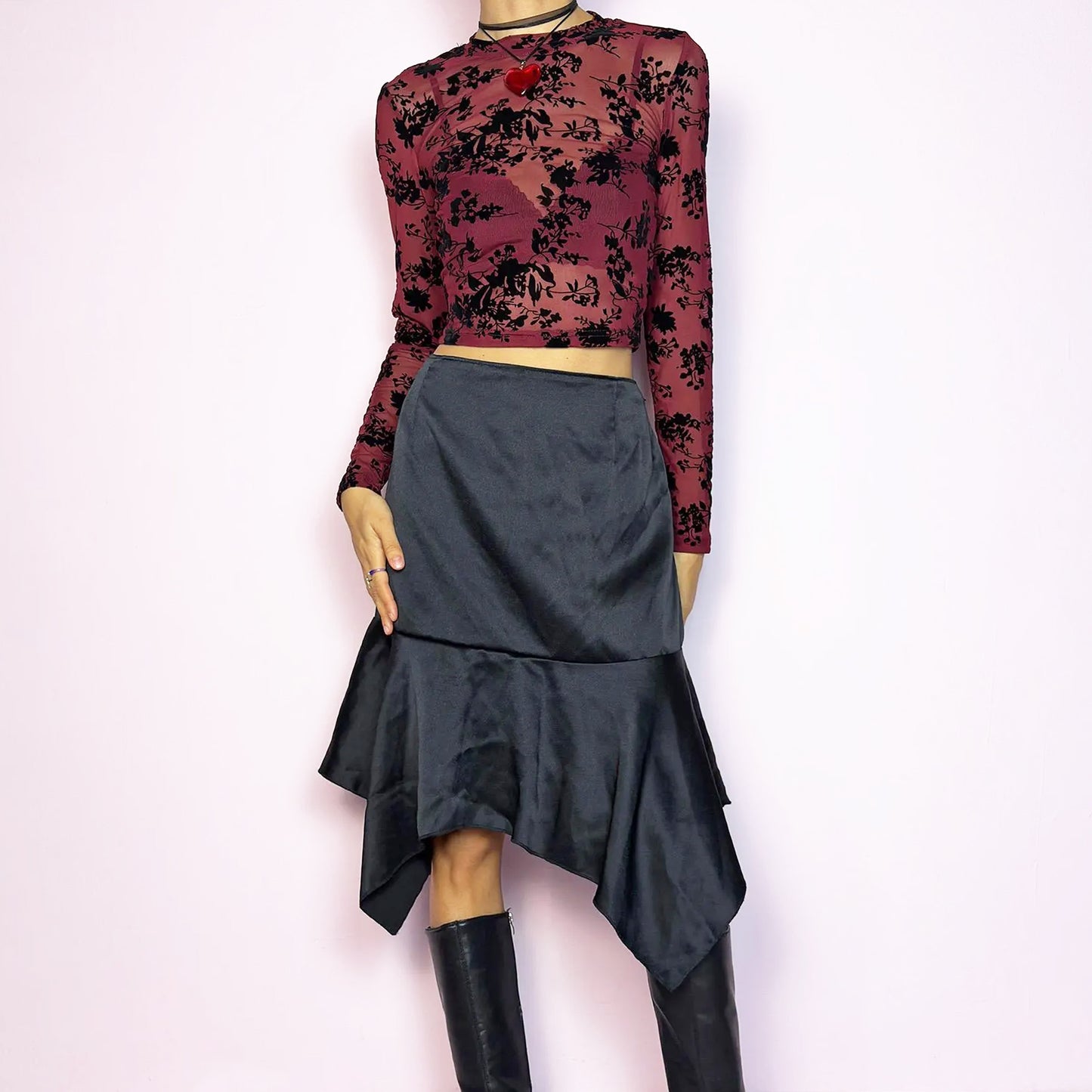 The Y2K Black Satin Asymmetric Skirt is a vintage 2000s stylish piece, featuring a satin-like finish with an asymmetrical handkerchief hemline for a dramatic flair and a size zipper closure. Perfect choice for party nights and chic night-out looks. Great vintage condition.