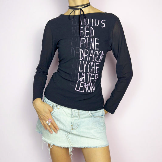 The Y2K Black Text Mesh Top is a vintage 2000s piece featuring a sheer mesh design with long sleeves, a scoop neckline and a words lettering print. Ideal for casual outfits. Great vintage condition.