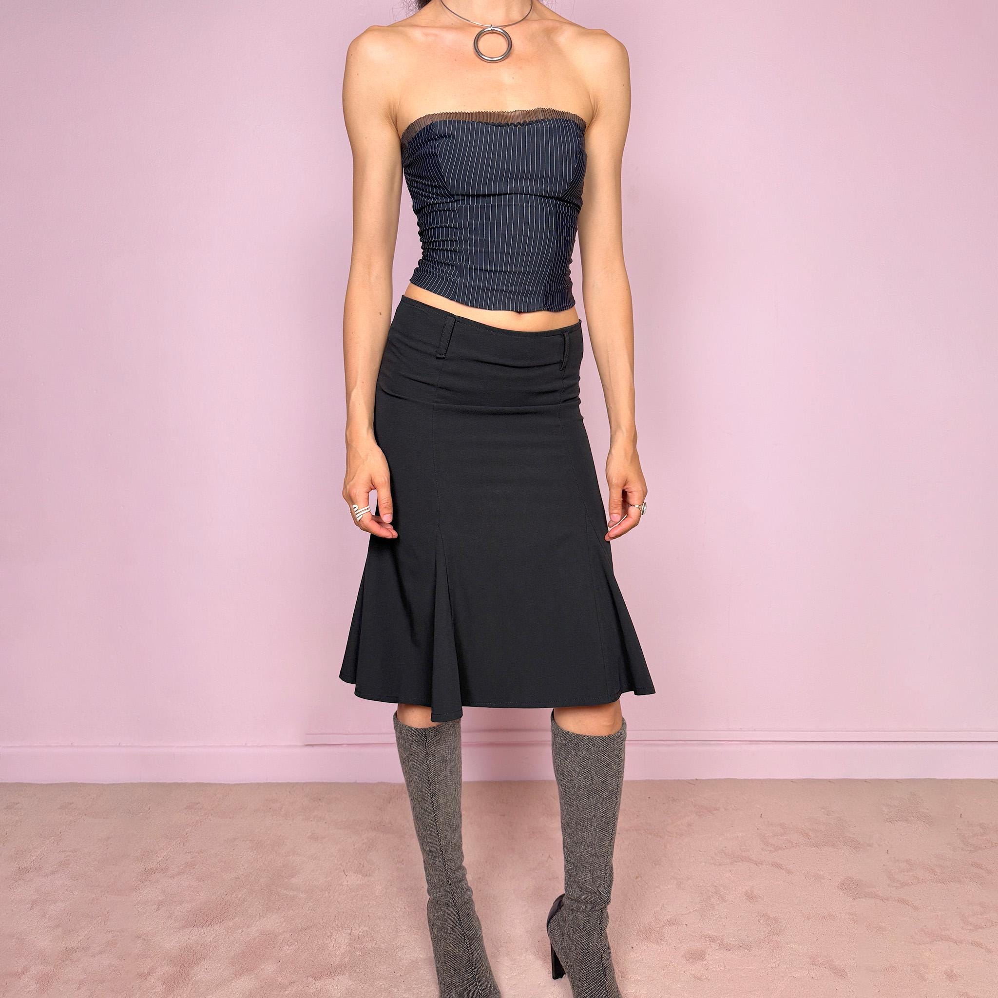 Vintage 2000s classic black midi skirt with a formal romantic feel. Features a sleek trumpet godet silhouette, side zip closure, belt loops, and a structured no-stretch fit. Perfect for elevated everyday or minimal styling. Can be worn mid rise for size XS or lower rise for XXS. Made in France from polyester, viscose, and elastane. Great vintage condition.